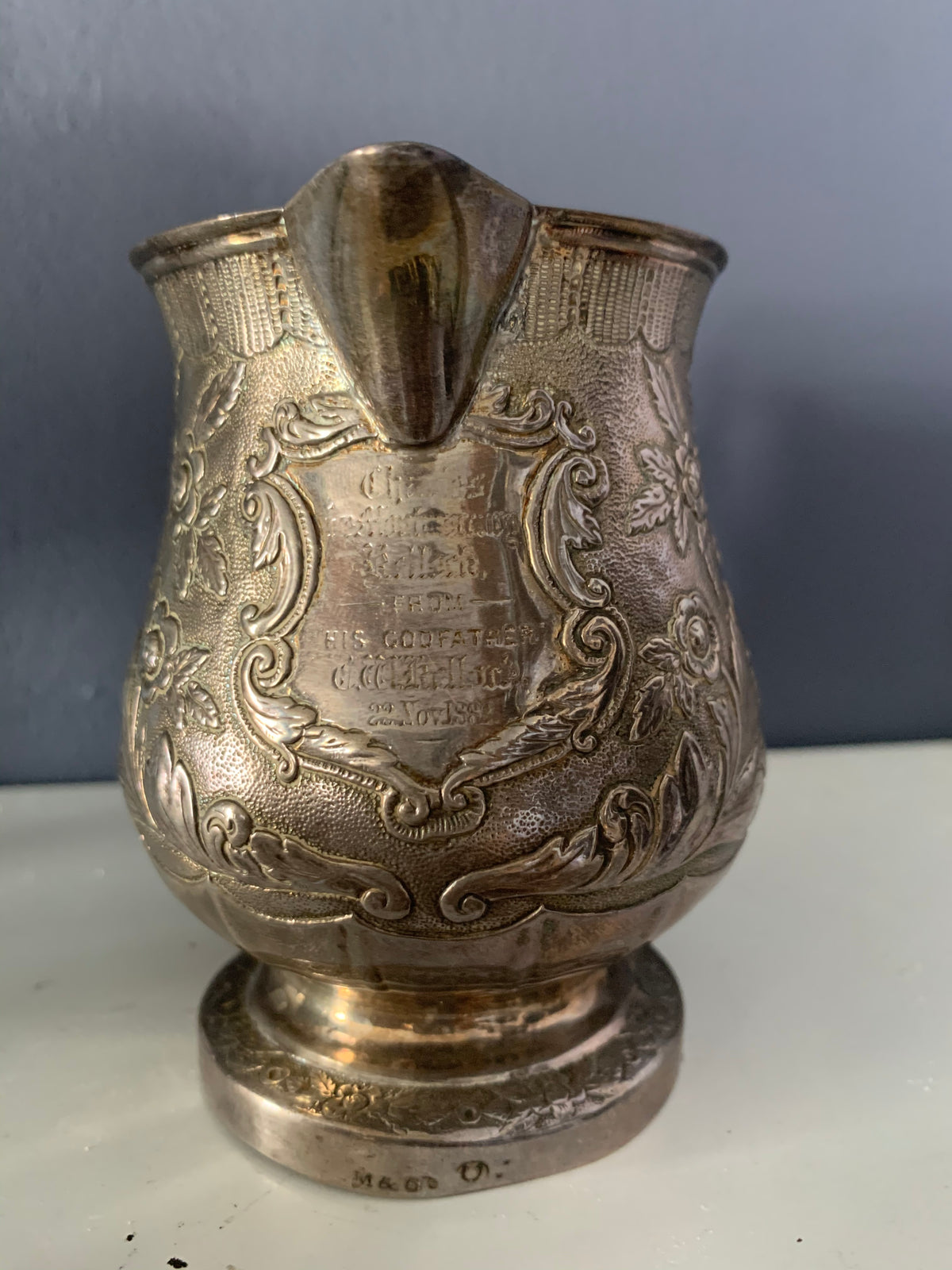A silver creamer (roses)