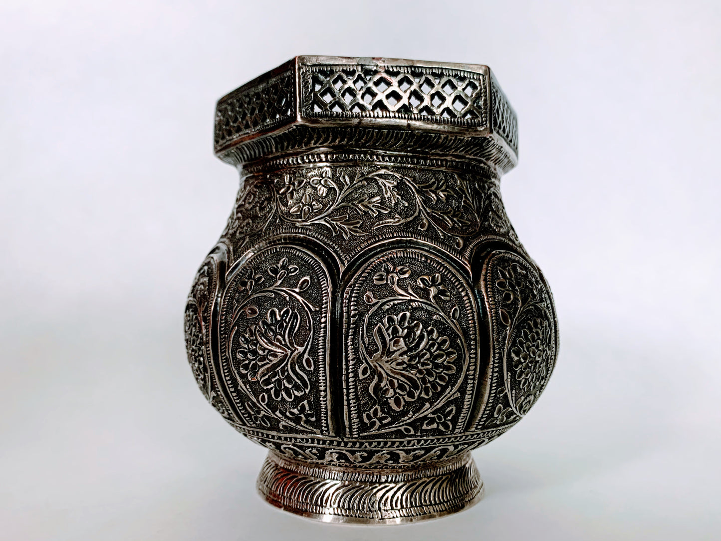 An exquisitely carved antique silver utensil -possibly a censer with floral details