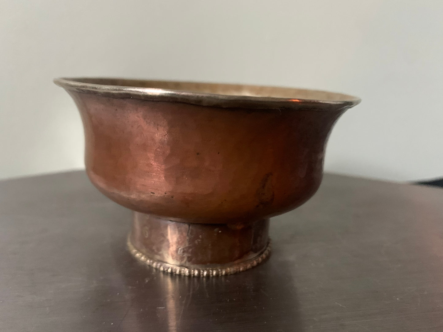 A copper bowl With silver details