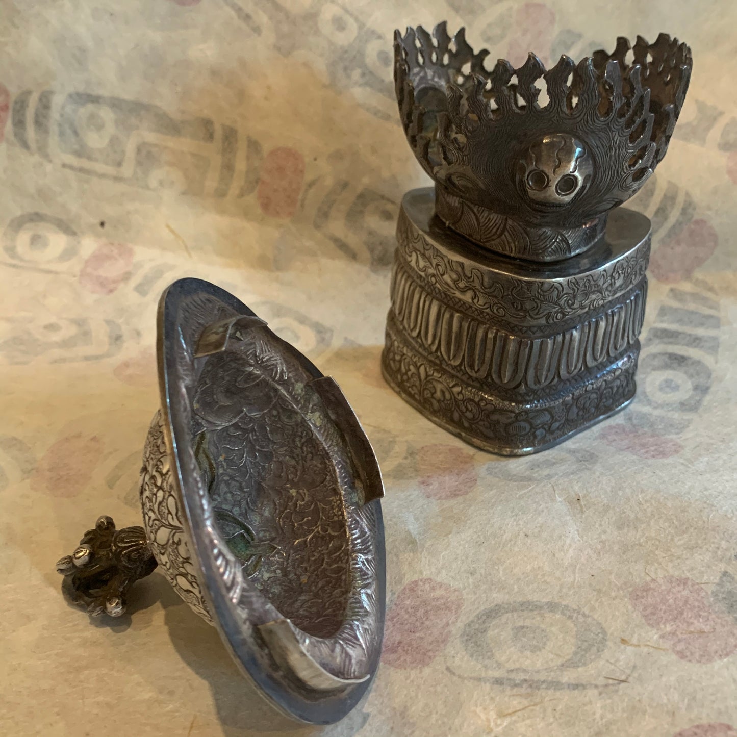 An antique silver kapala stand and cover