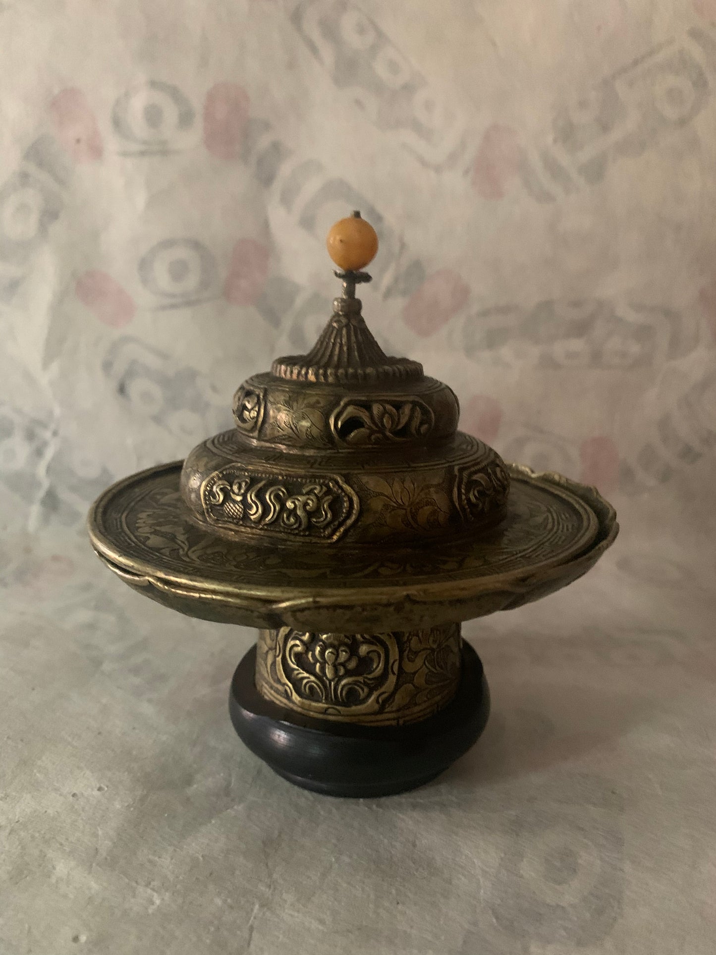 An antique metal cup stand