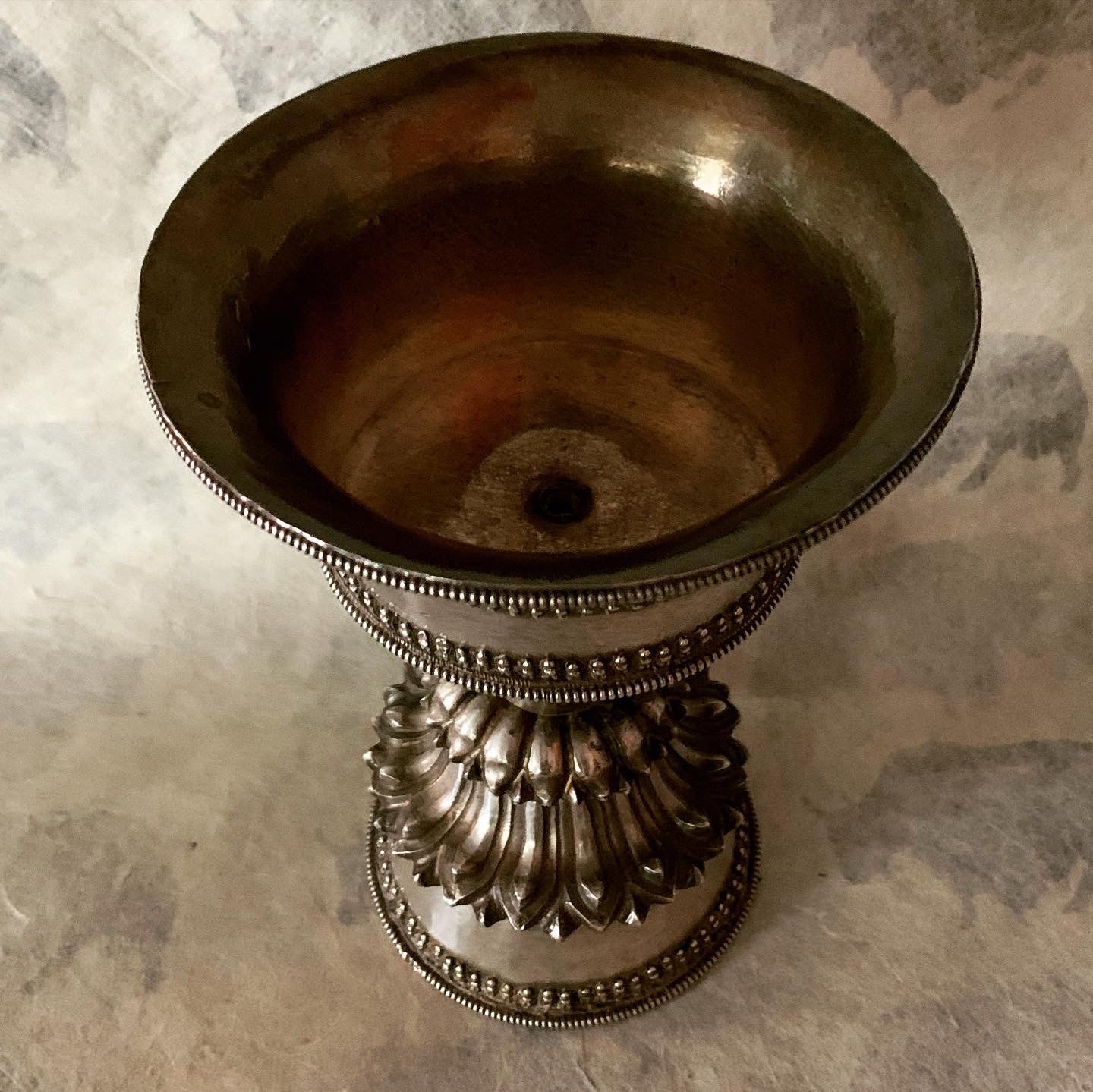 An antique Tibetan silver butterlamp