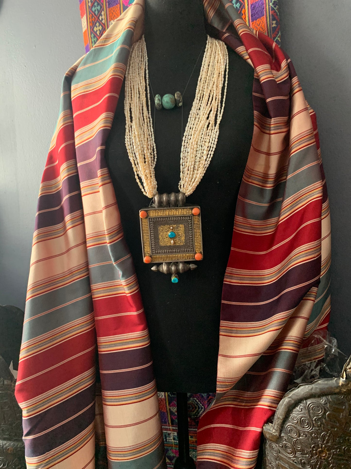 A Tibetan silver ghau with pearls and turquoise.
