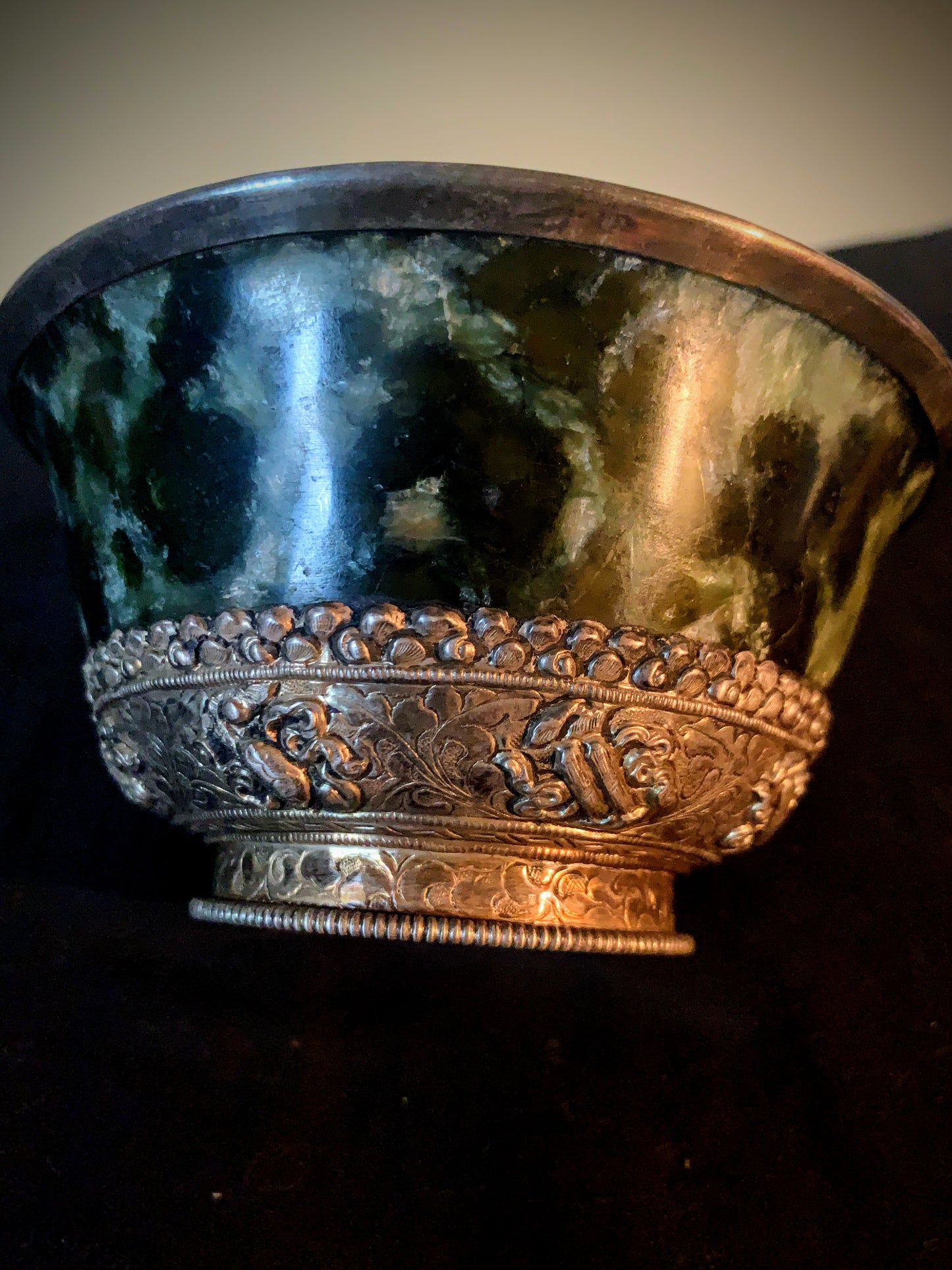 A jade bowl with silver details