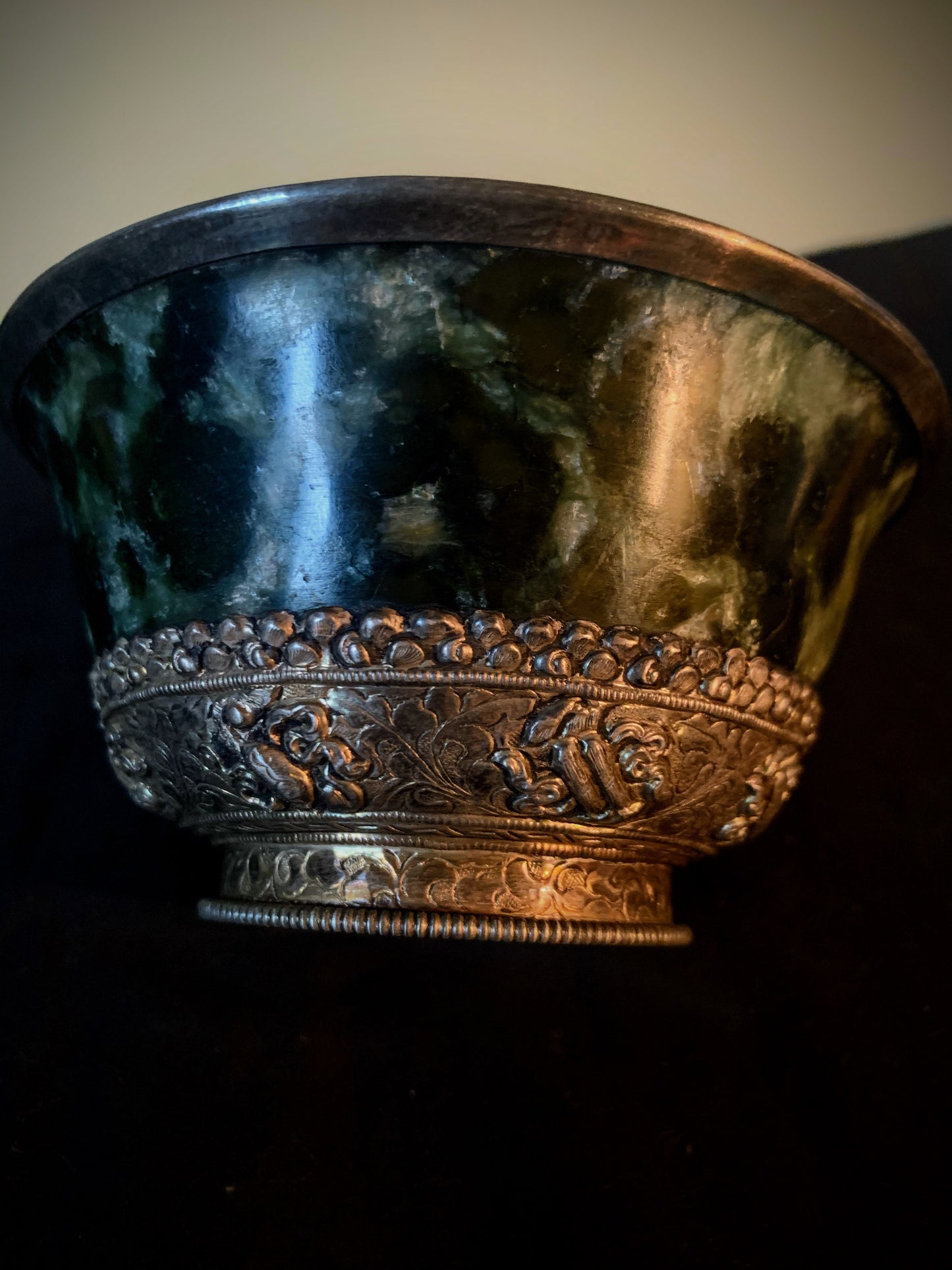 A jade bowl with silver details