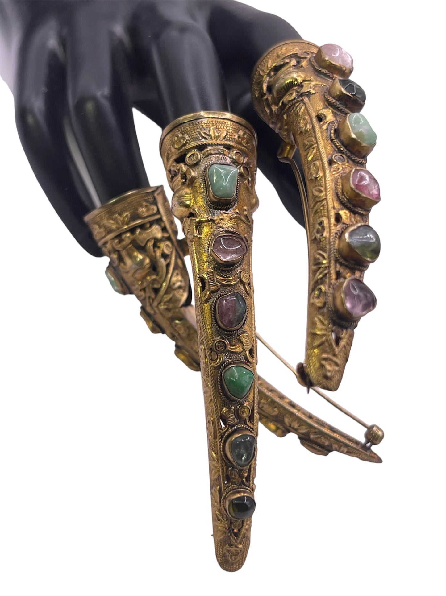 A set of three vintage gilded silver nail covers