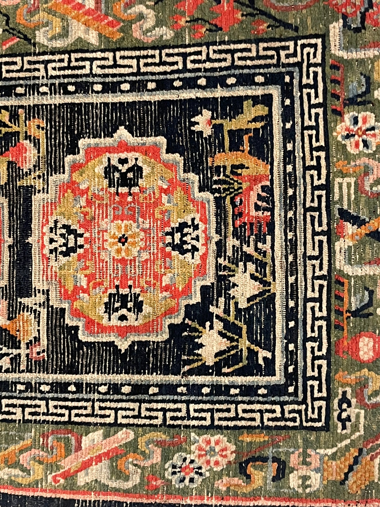 An antique Tibetan residential rug with medallions