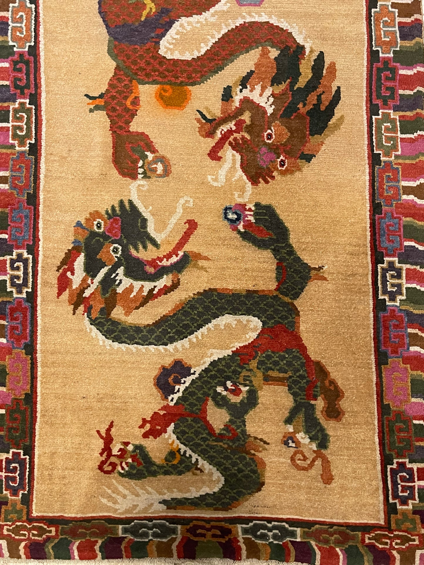 A vintage mid 20th c. Tibetan rug with dragons