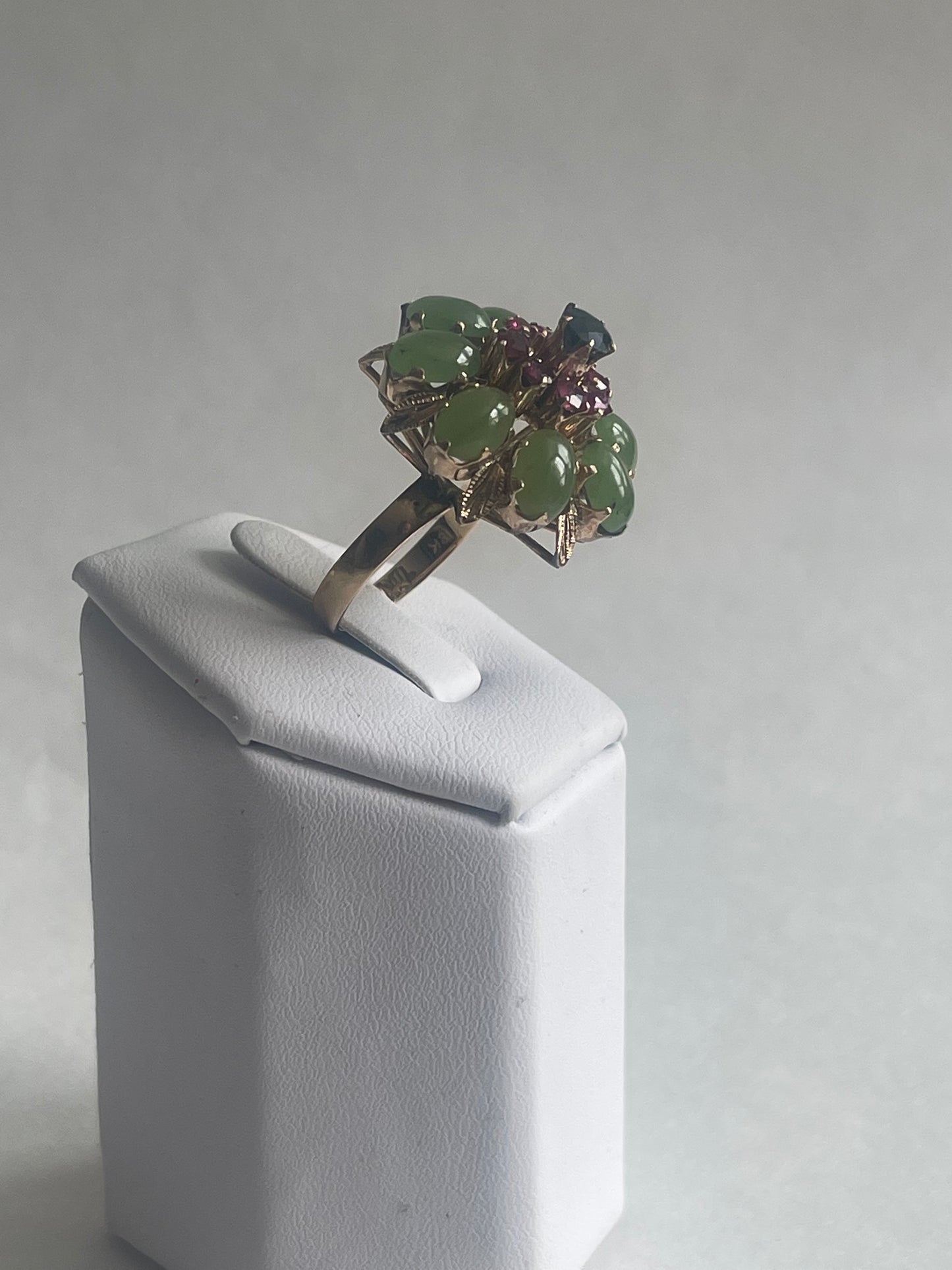 A vintage jade, ruby and sapphire cocktail ring
