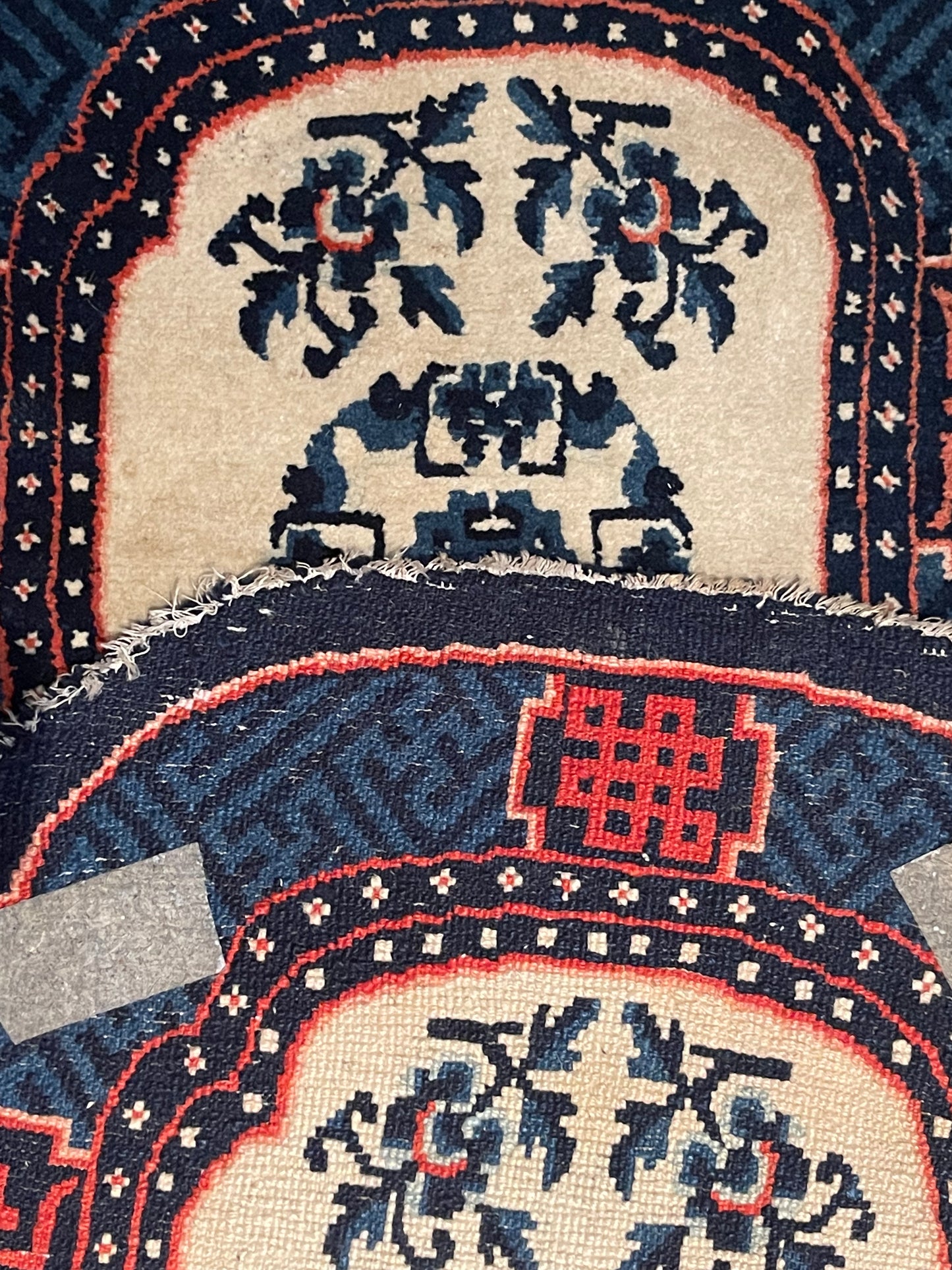 A vintage Tibetan indigo rounded woolen saddle rug