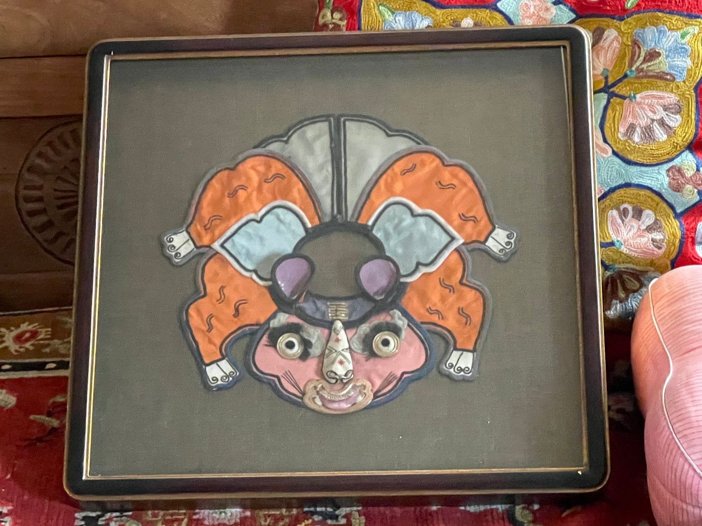 An antique childrens collar with an animal design in a box frame