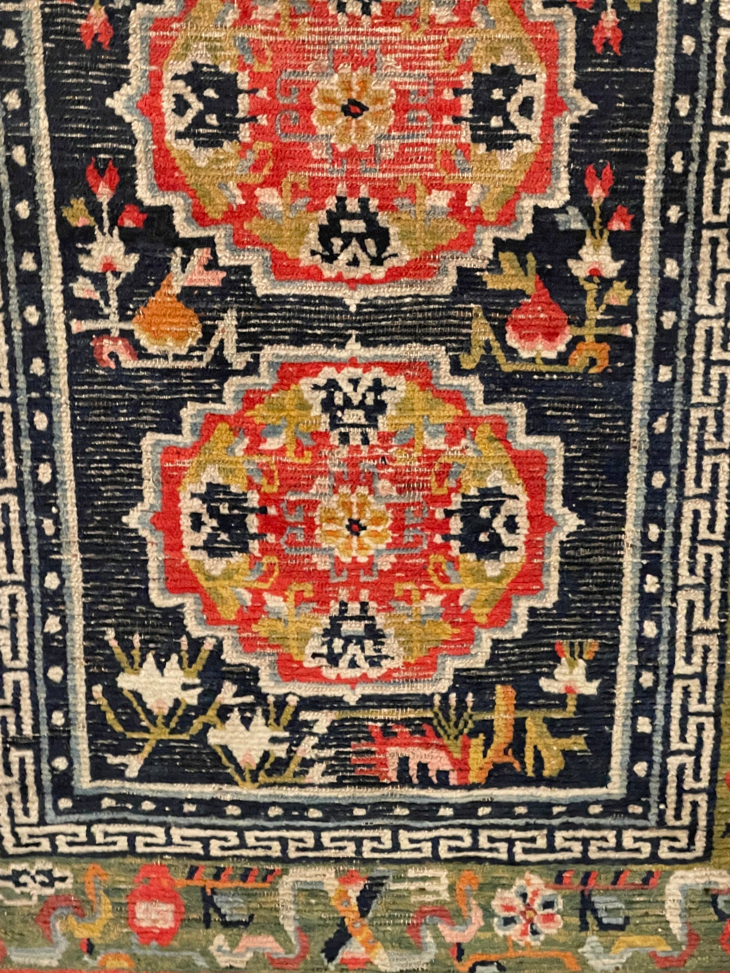 An antique Tibetan residential rug with medallions