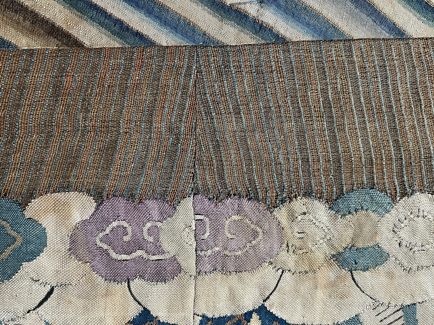 An antique framed Chinese silk kesi of a pair of dragons