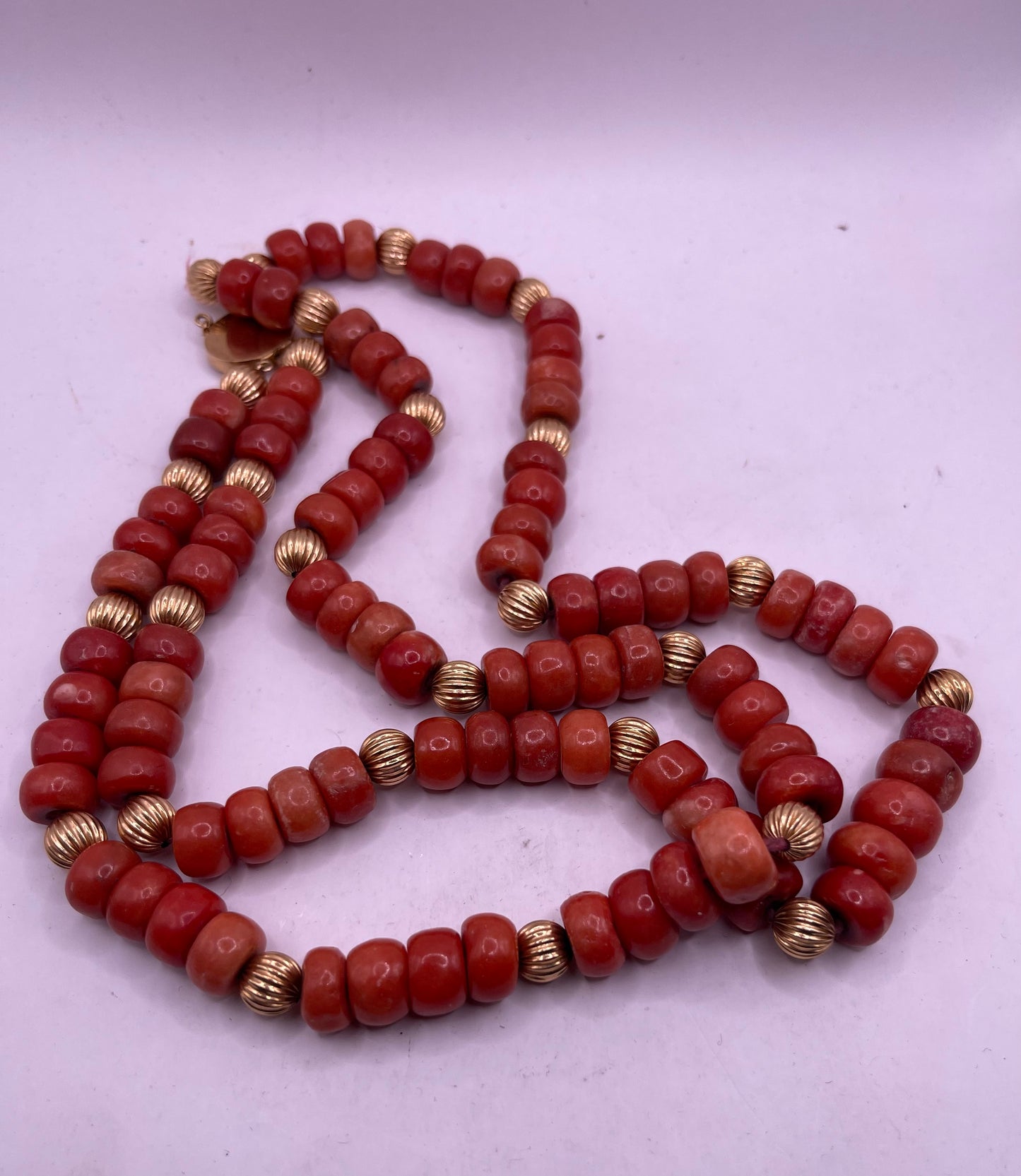 A coral and gold bead necklace