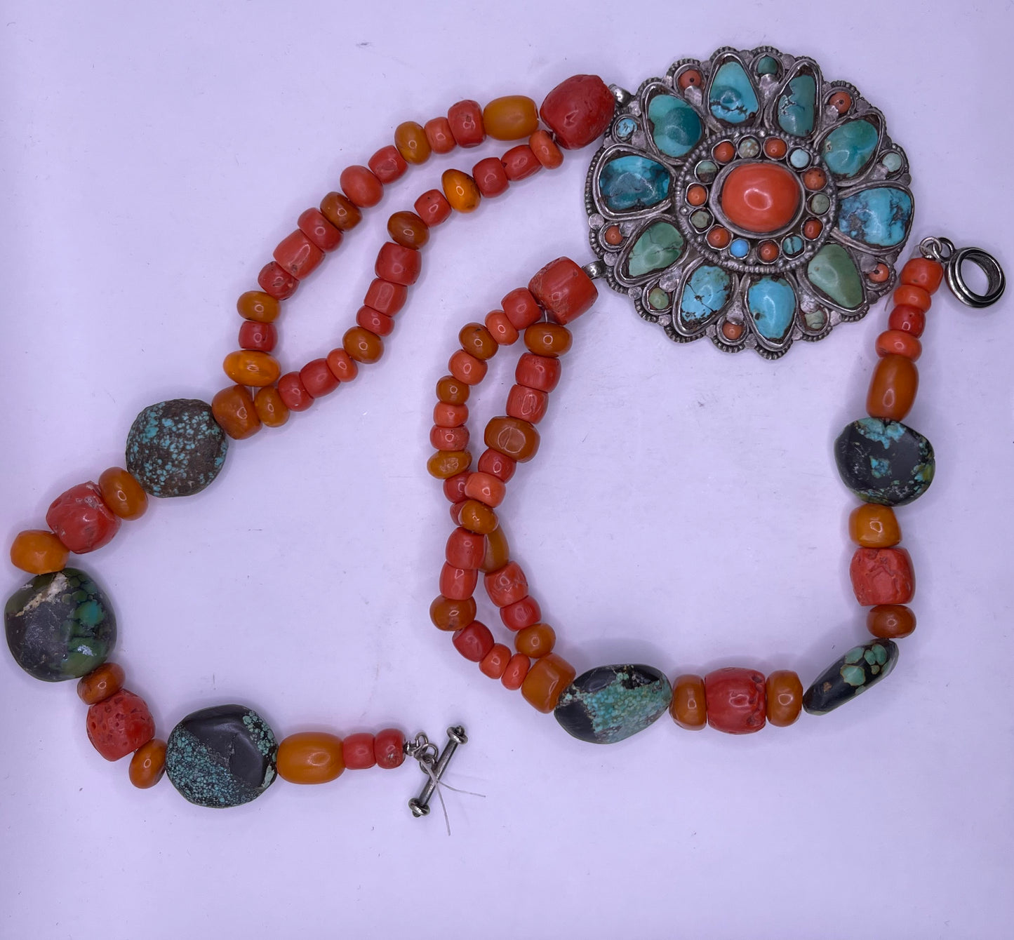 Coral, amber and turquoise necklace with a turquoise and coral silver pendant