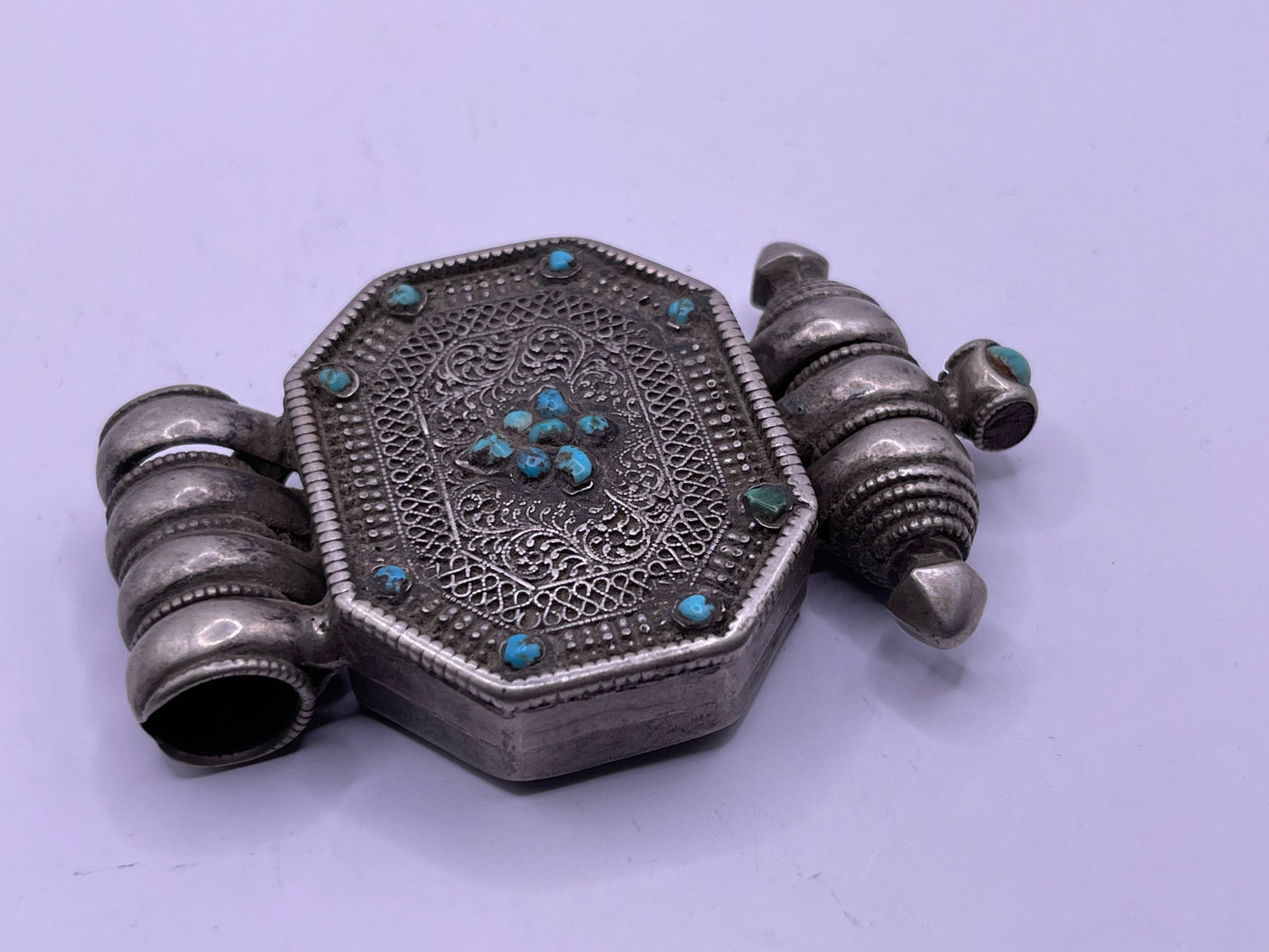 An antique 19th C., few Tibetan silver ghau with silver filigree and turquoise.
