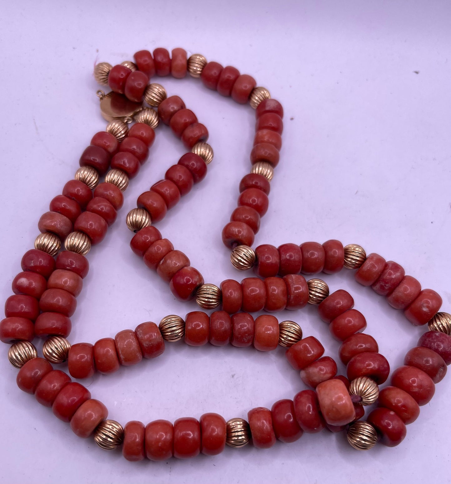 A coral and gold bead necklace