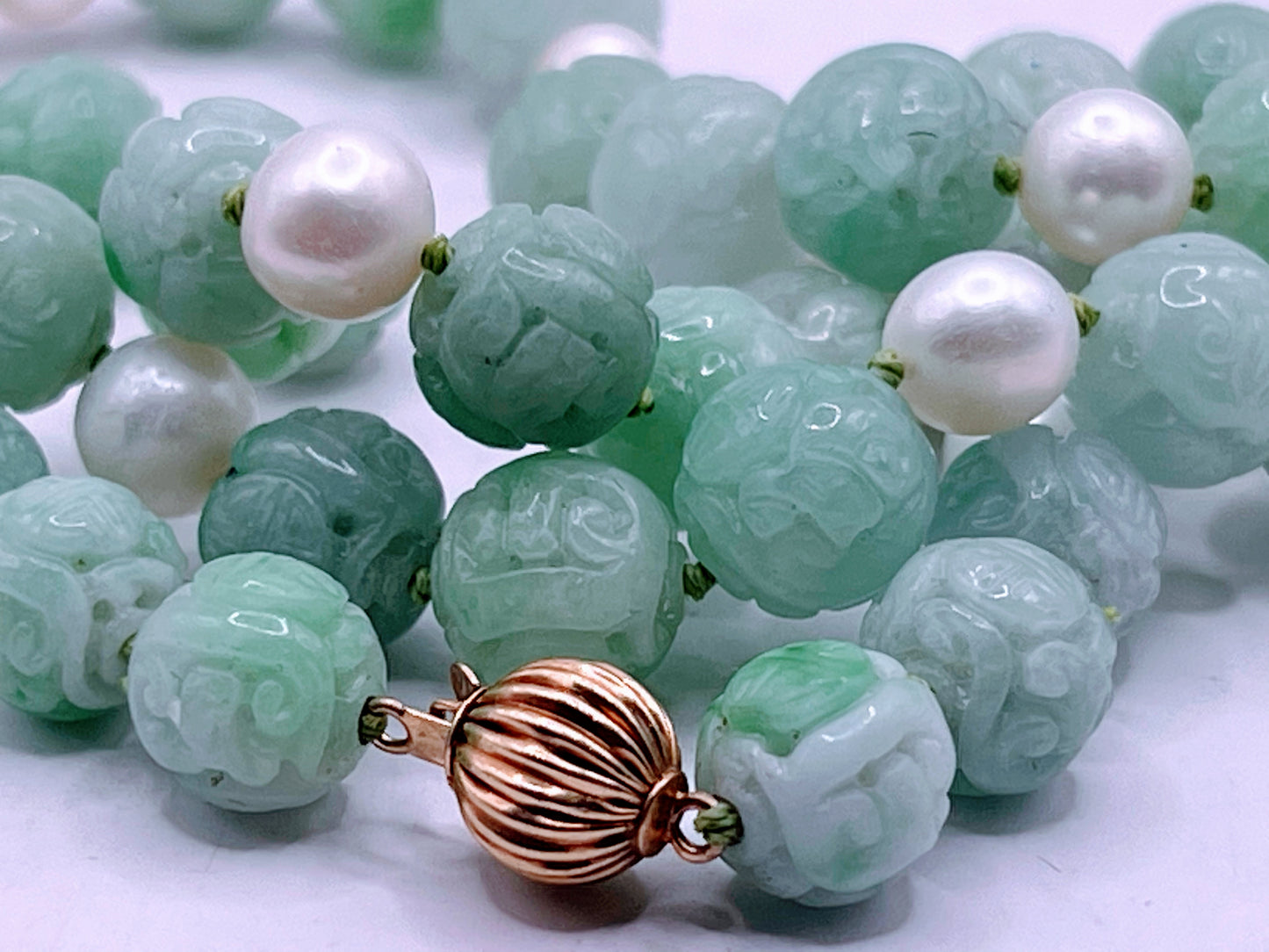 A necklace with vintage carved jade shou beads and pearls
