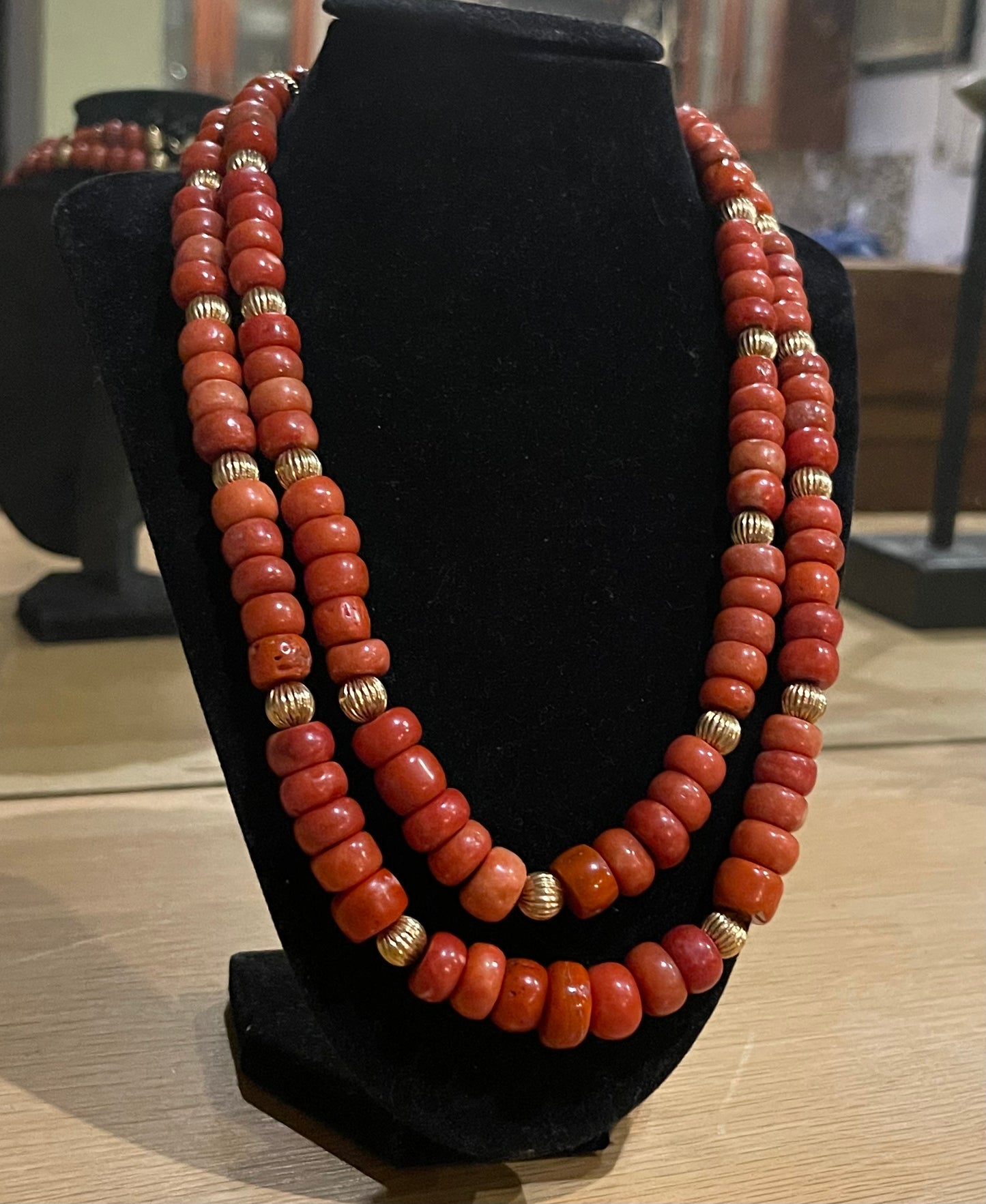 A coral and gold bead necklace