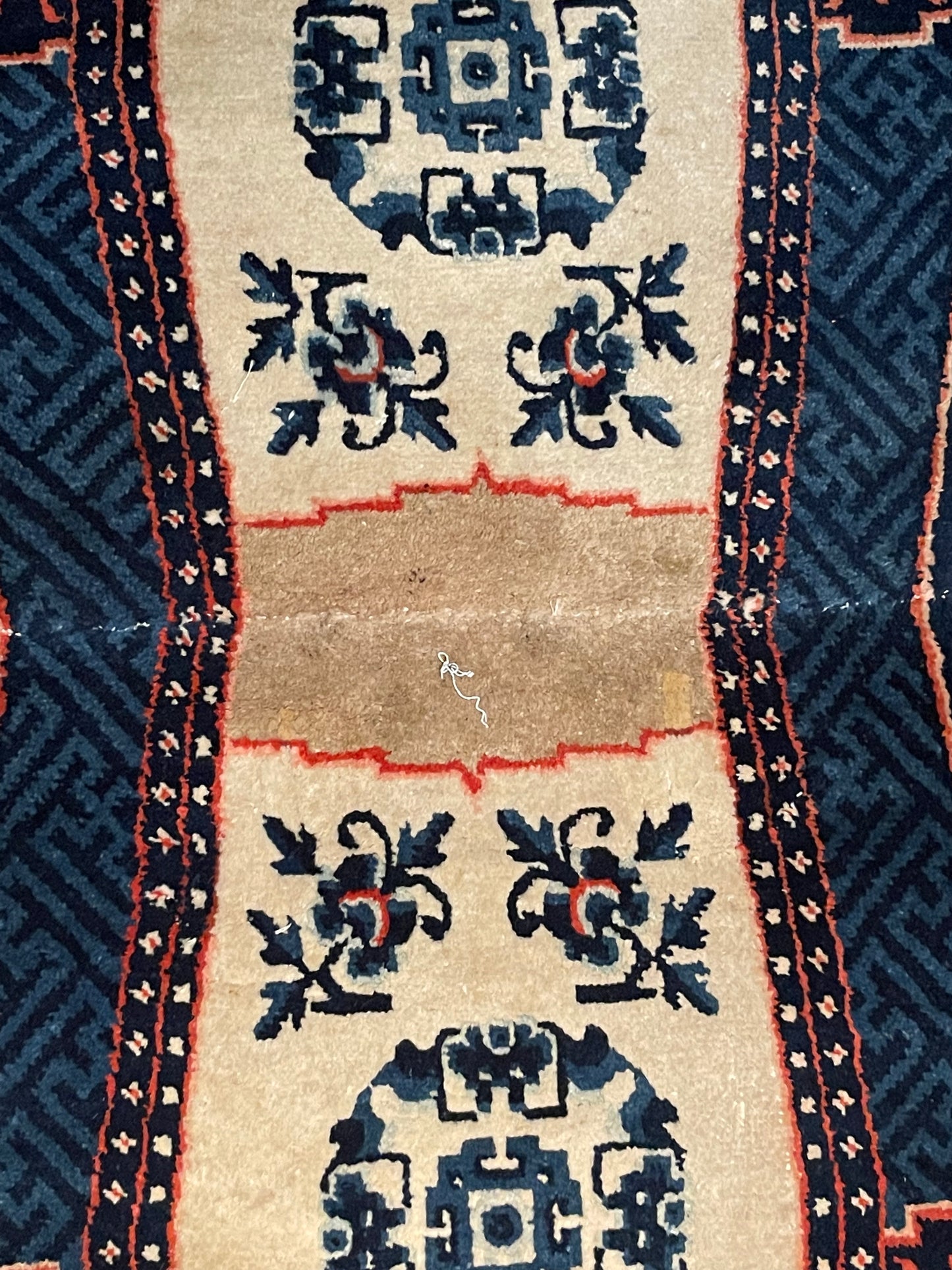 A vintage Tibetan indigo rounded woolen saddle rug