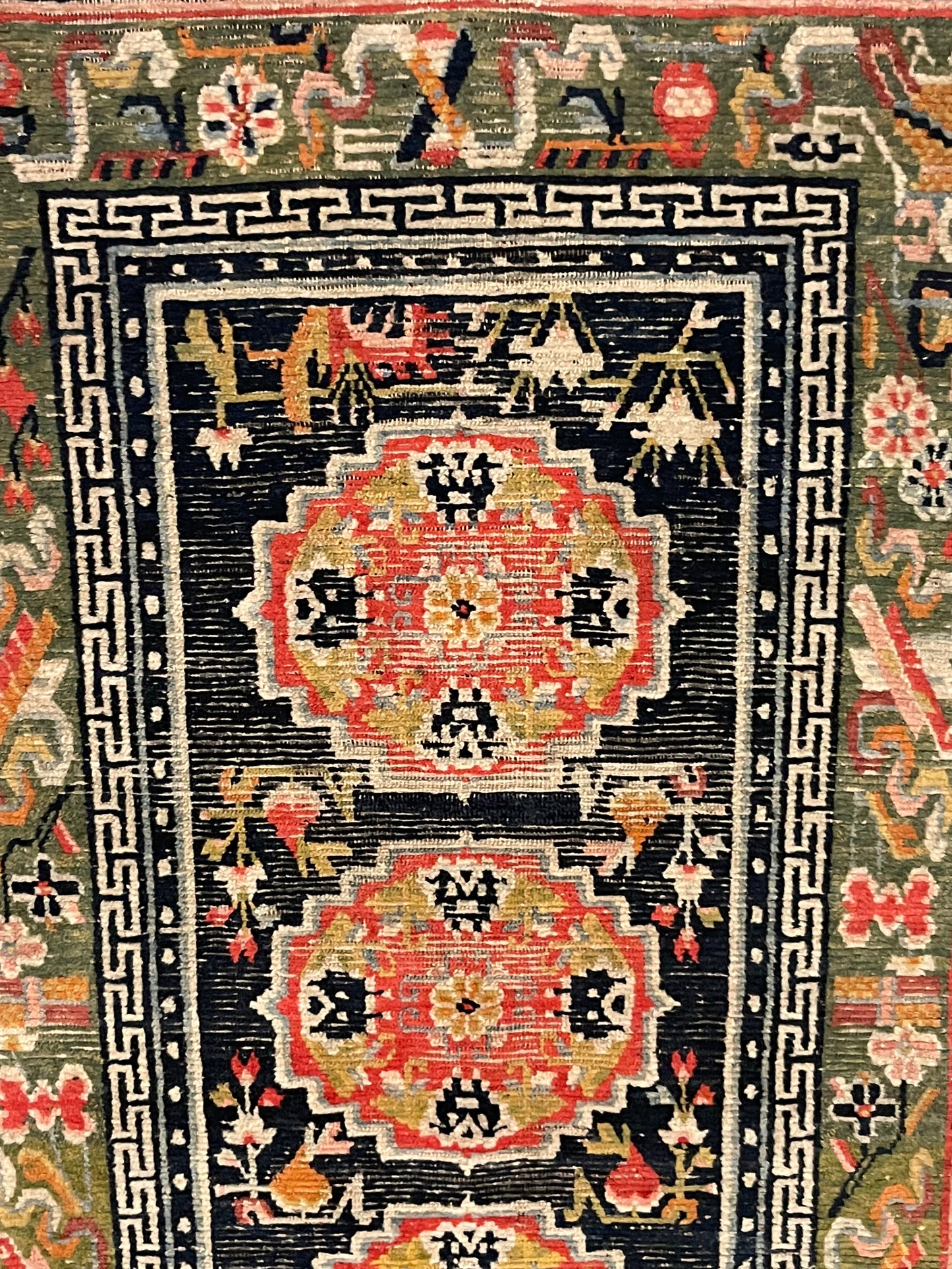 An antique Tibetan residential rug with medallions