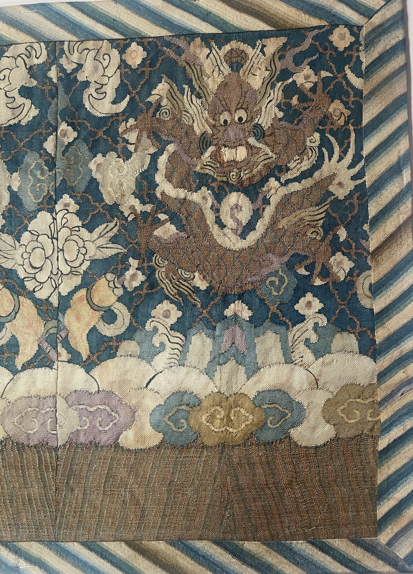 An antique framed Chinese silk kesi of a pair of dragons