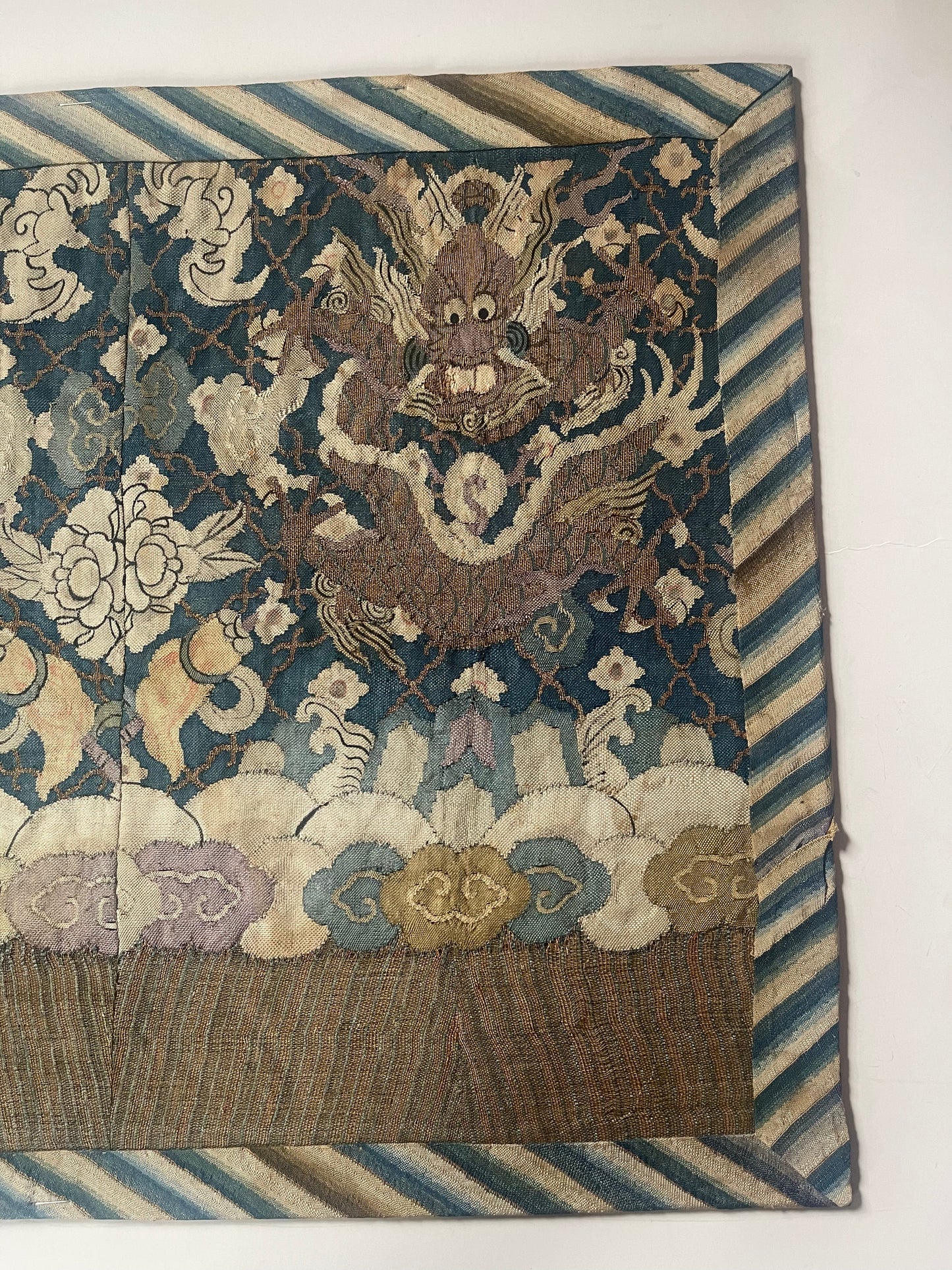 An antique framed Chinese silk kesi of a pair of dragons