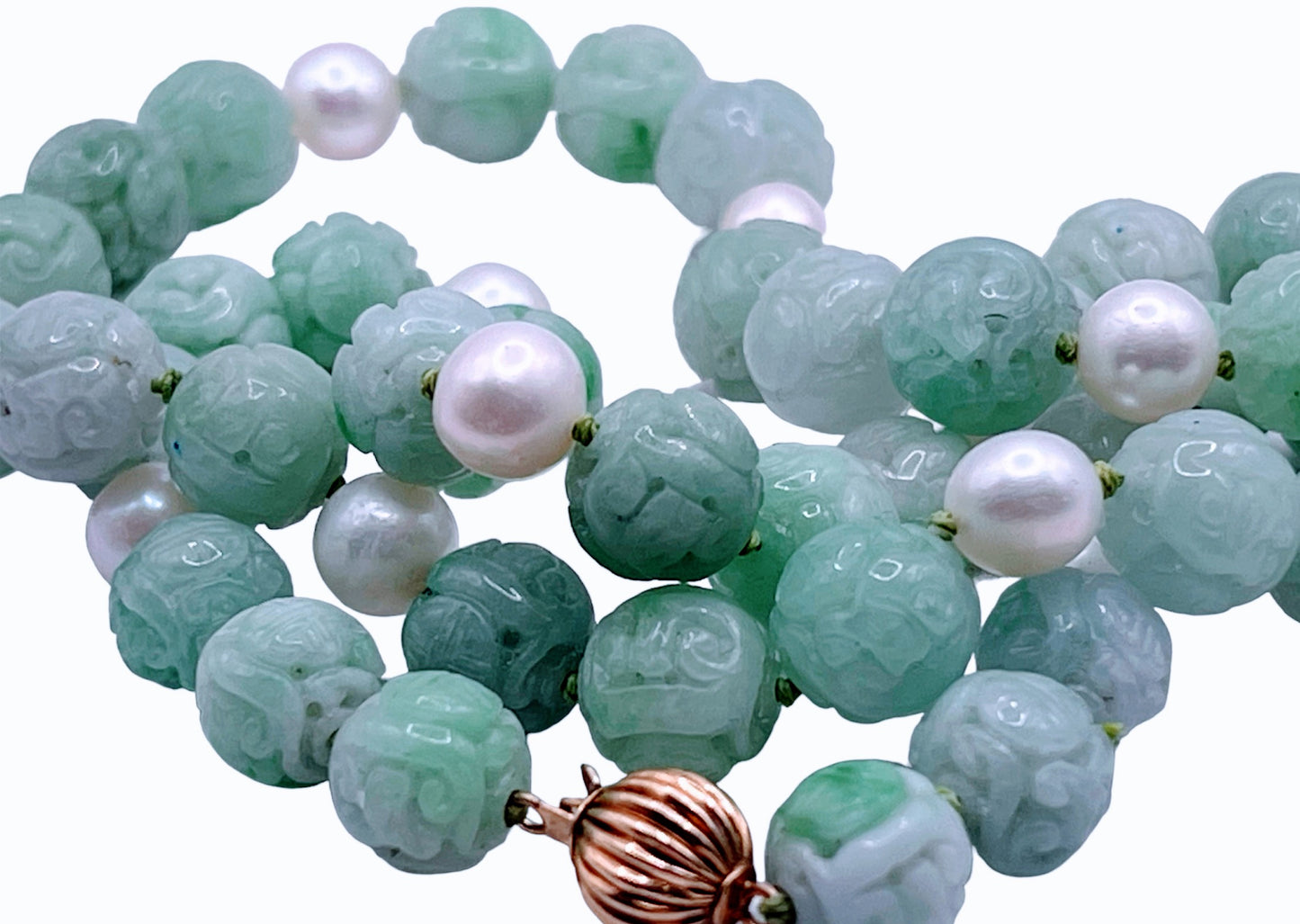 A necklace with vintage carved jade shou beads and pearls