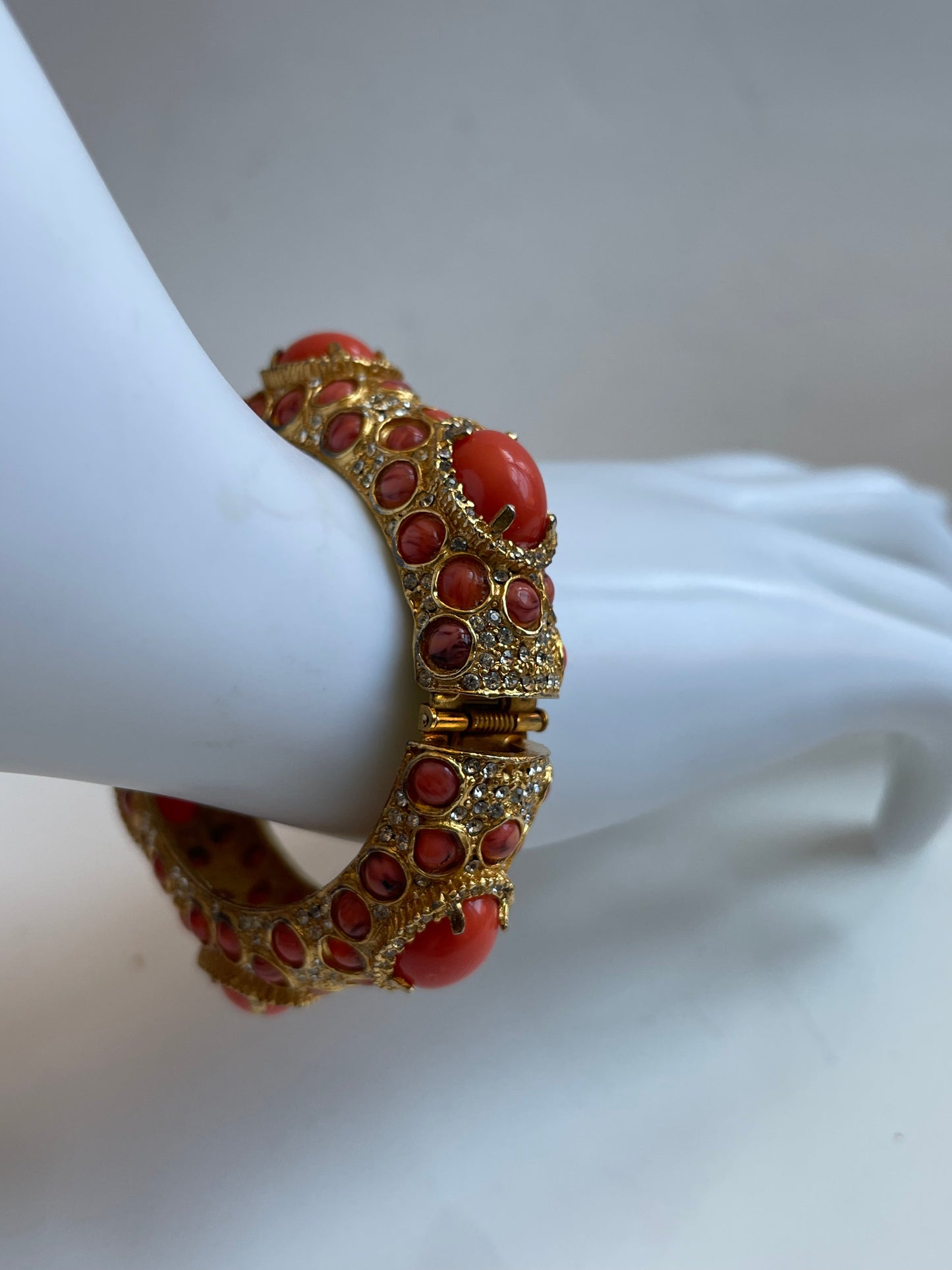 A vintage KJL coral like bracelet with rhinestones