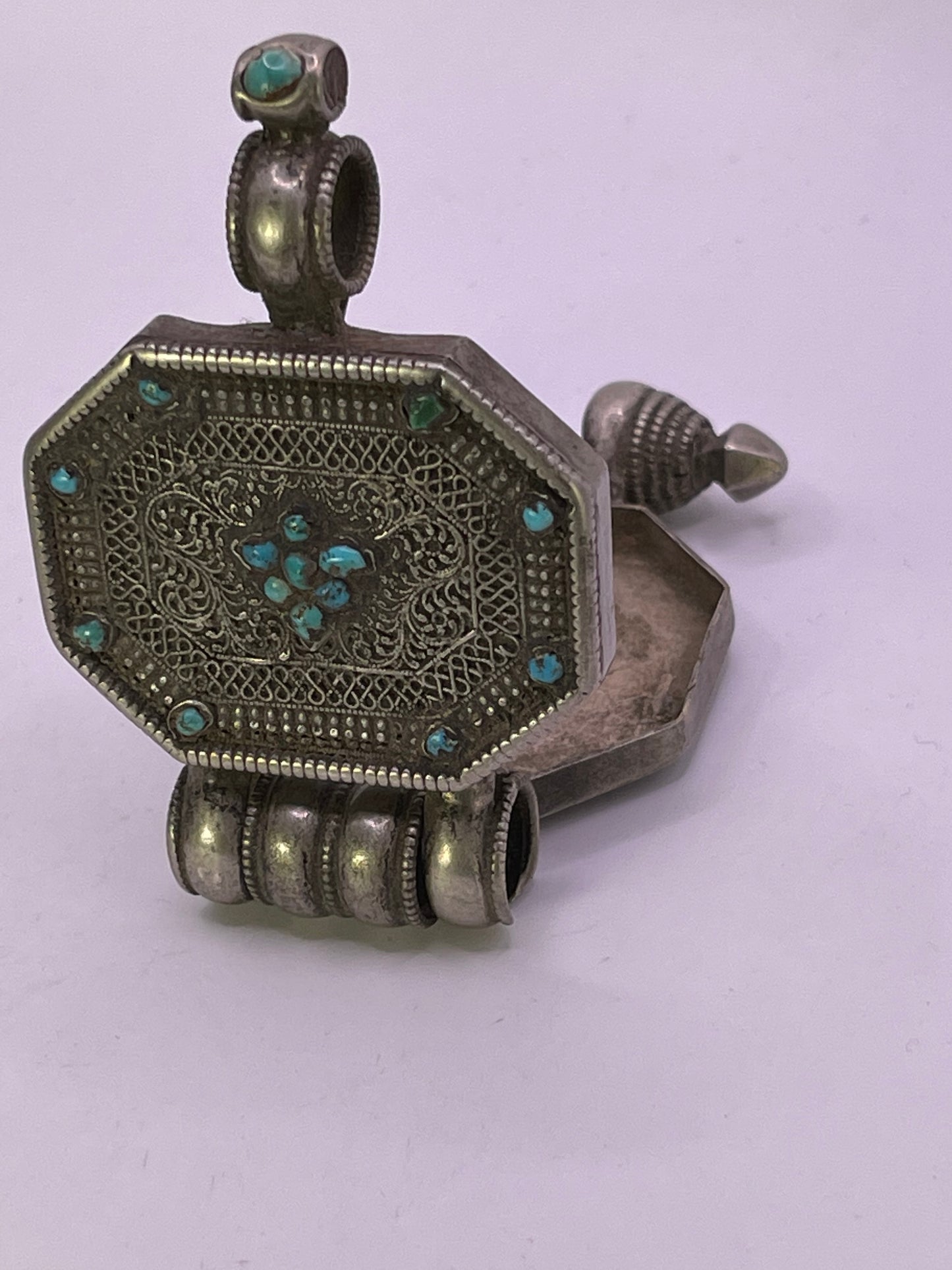 An antique 19th C., few Tibetan silver ghau with silver filigree and turquoise.