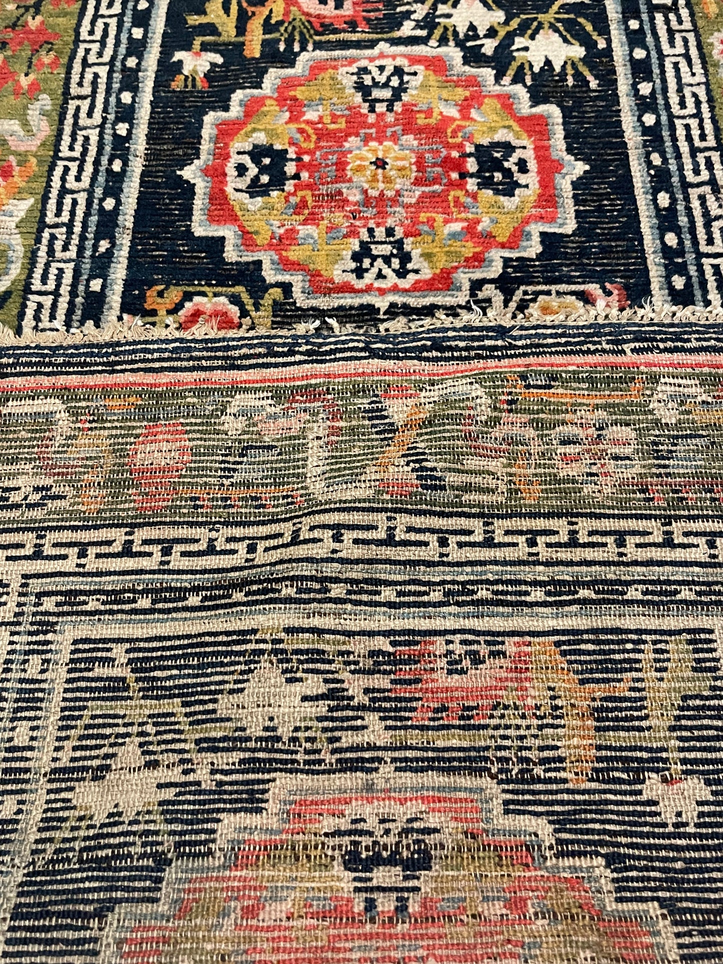 An antique Tibetan residential rug with medallions