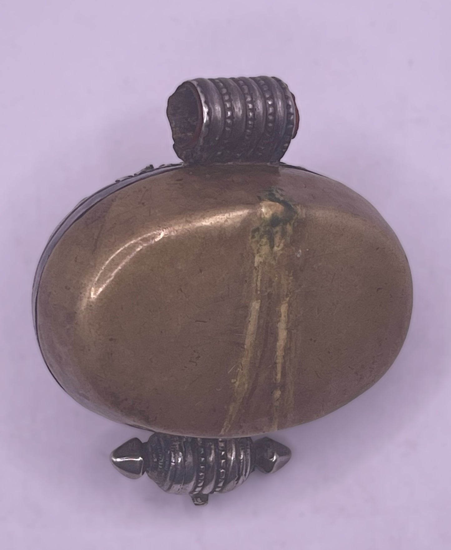 An antique silver and coral ghau amulet