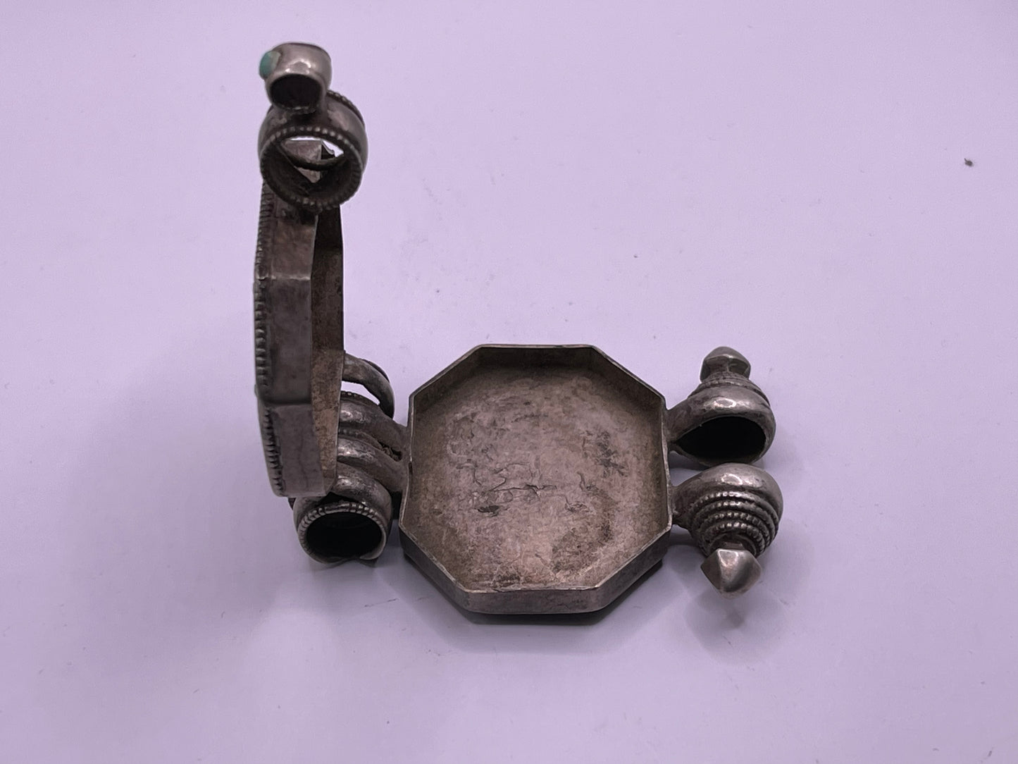 An antique 19th C., few Tibetan silver ghau with silver filigree and turquoise.
