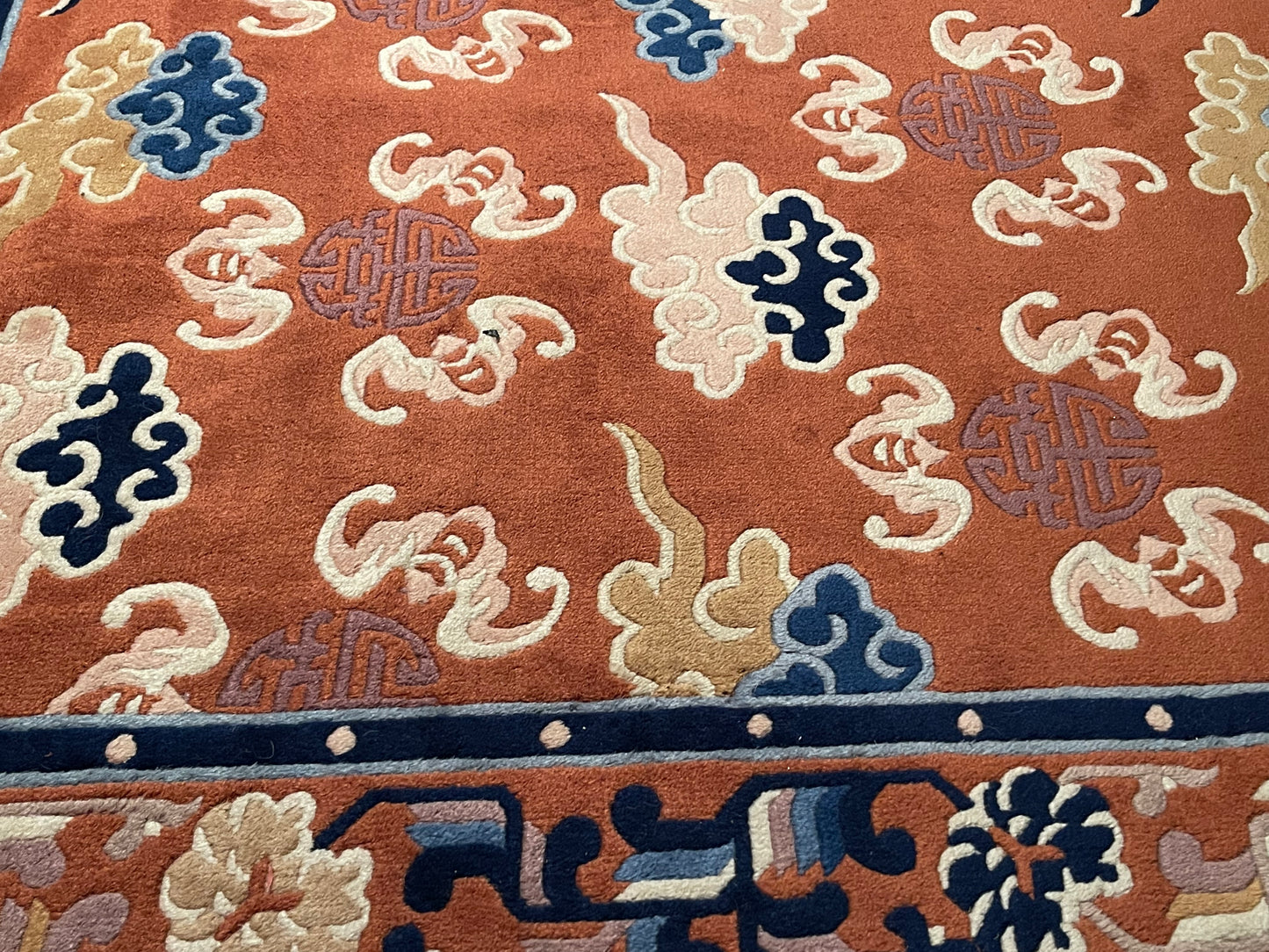 A mid 20th C. Peking rug with clouds and bats motifs