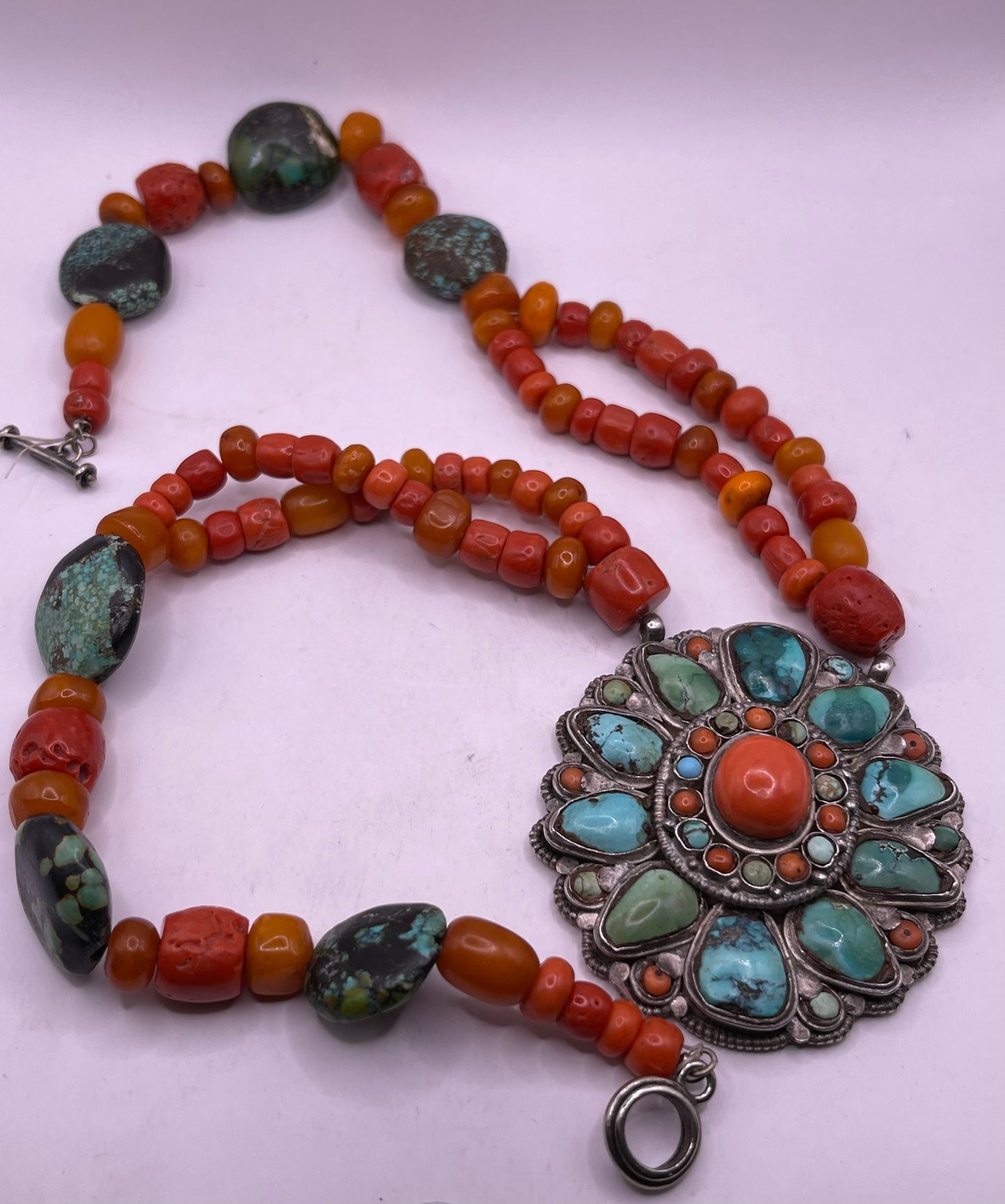 Coral, amber and turquoise necklace with a turquoise and coral silver pendant