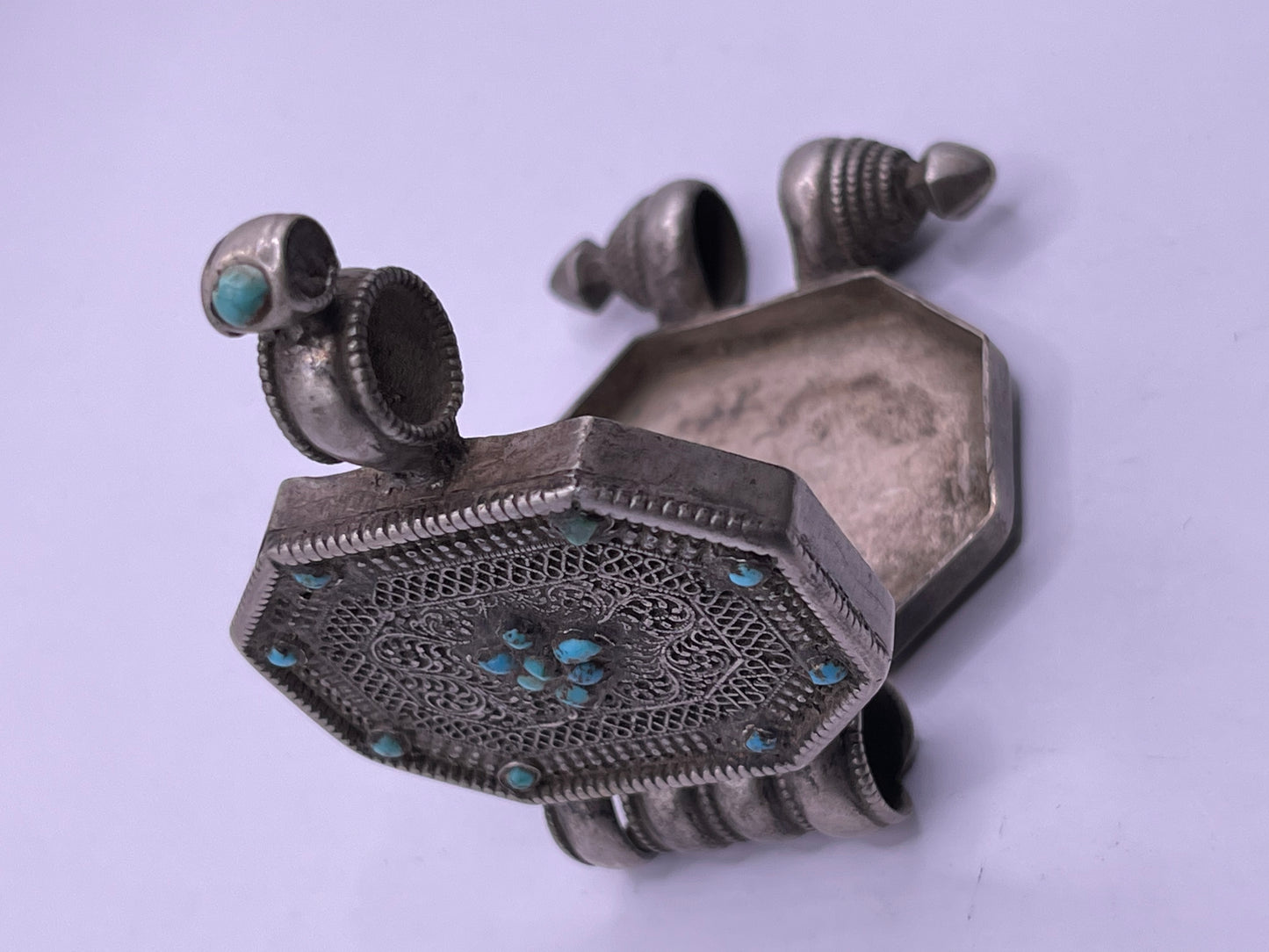 An antique 19th C., few Tibetan silver ghau with silver filigree and turquoise.