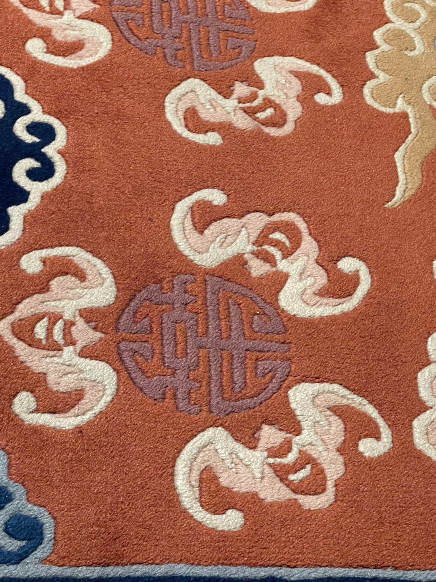 A mid 20th C. Peking rug with clouds and bats motifs