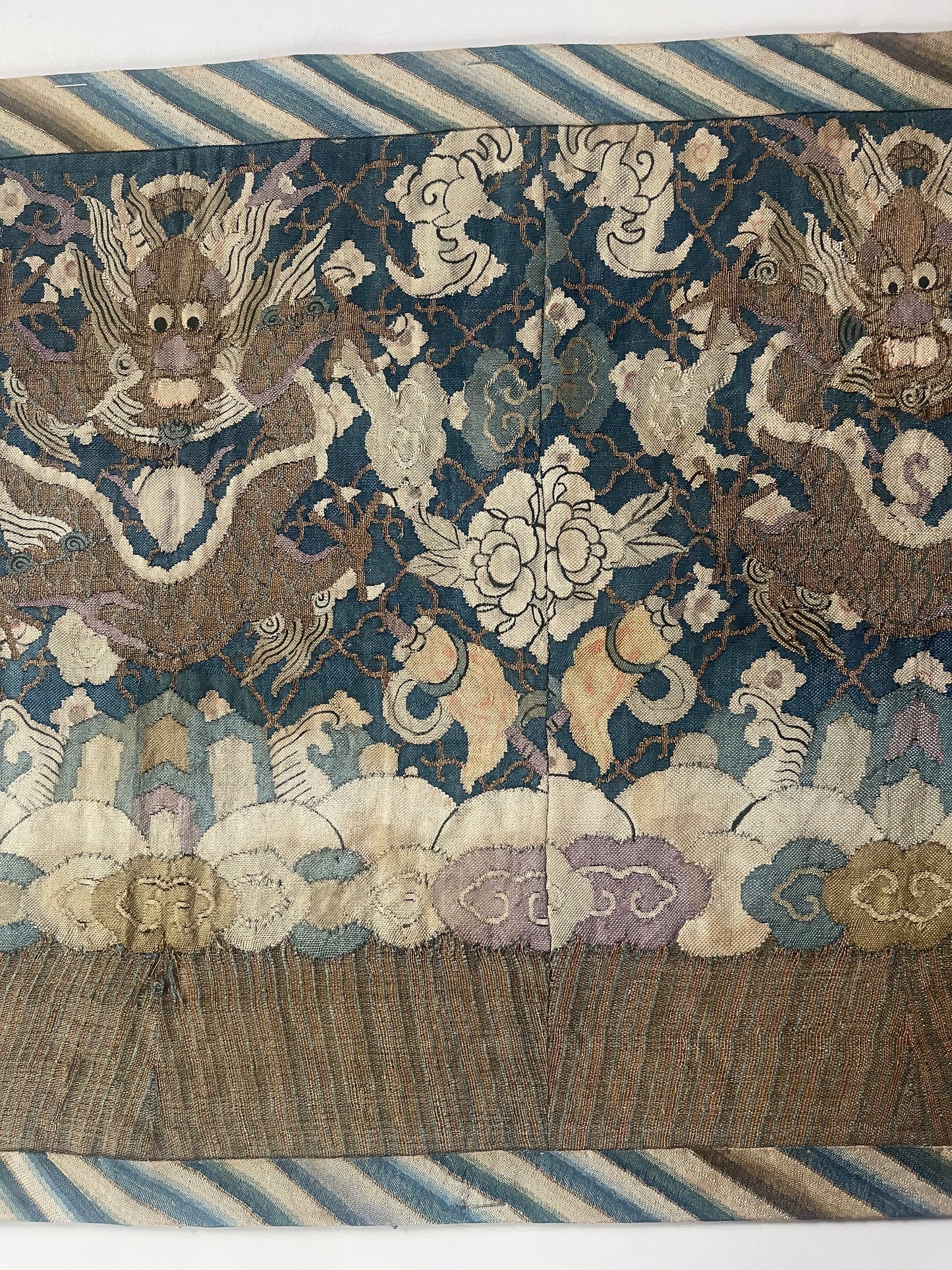 An antique framed Chinese silk kesi of a pair of dragons