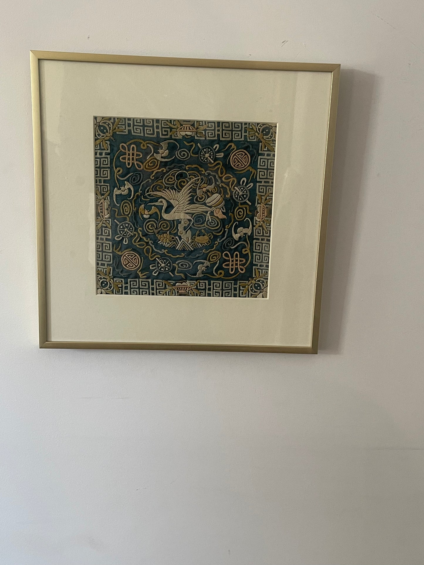 An antique framed Chinese embroidered textile fragment