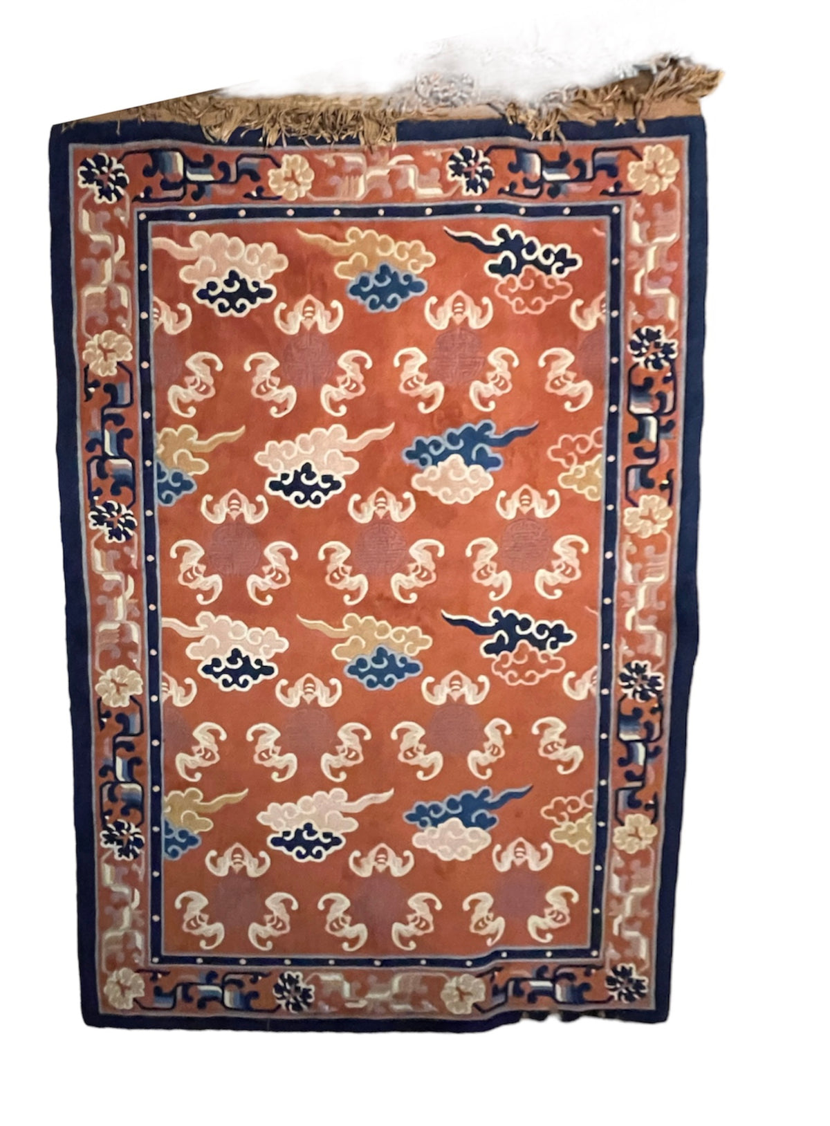 A mid 20th C. Peking rug with clouds and bats motifs