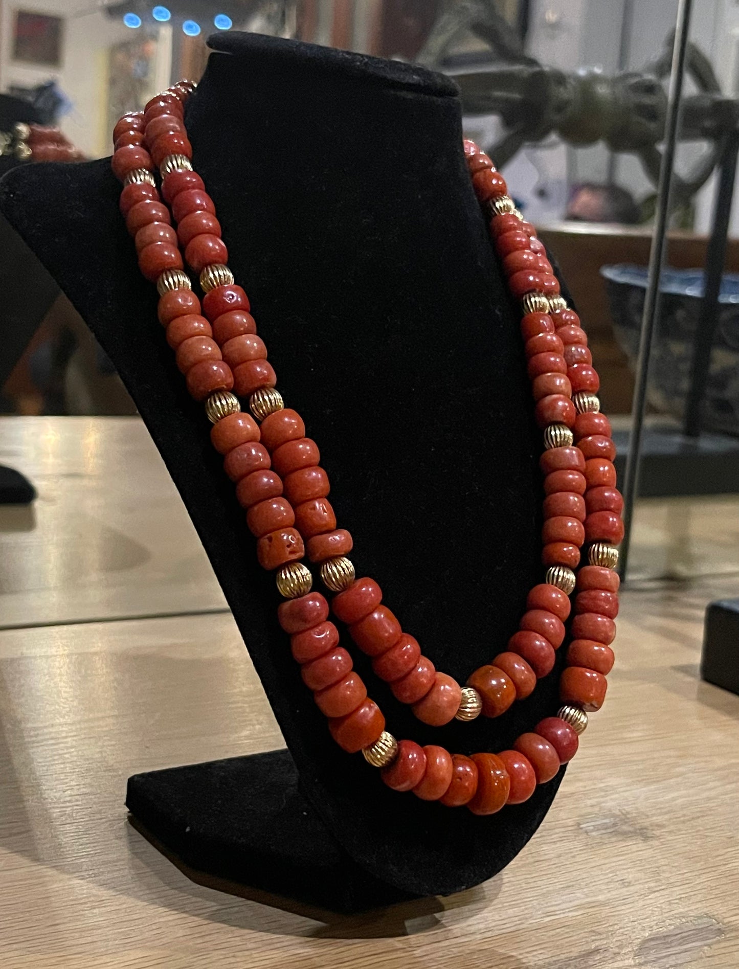 A coral and gold bead necklace
