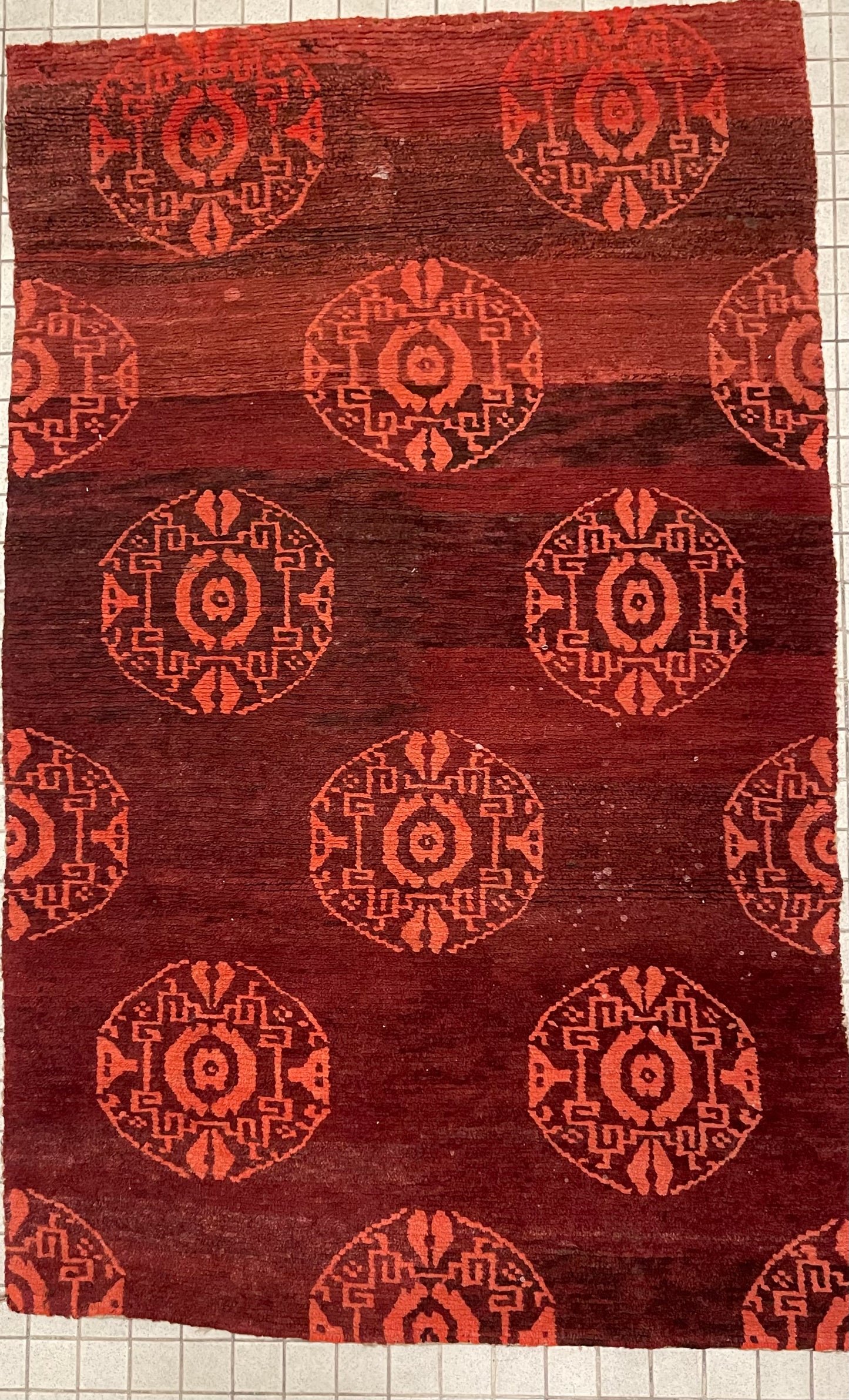 An antique Tibetan rug with coin motifs