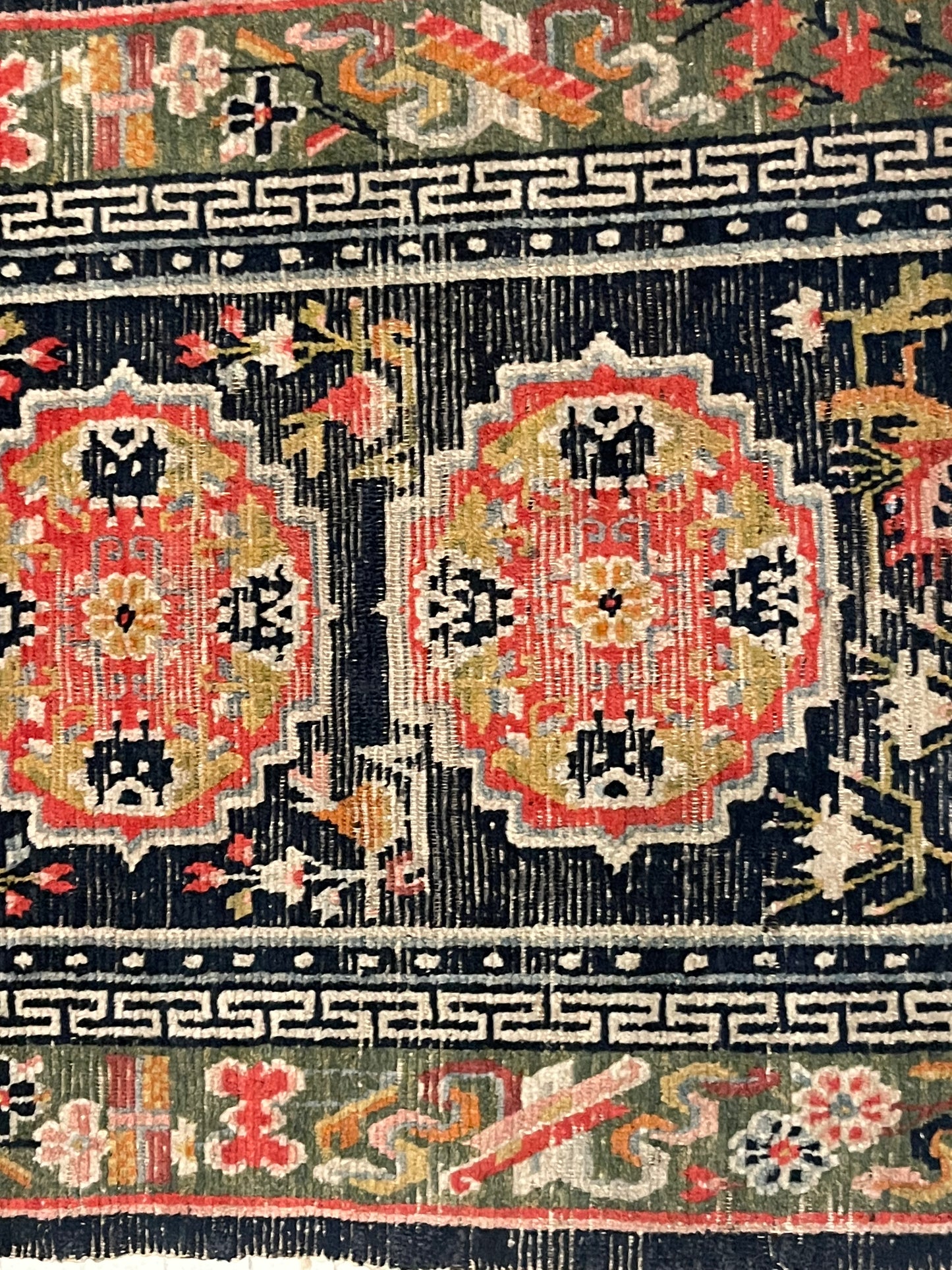 An antique Tibetan residential rug with medallions