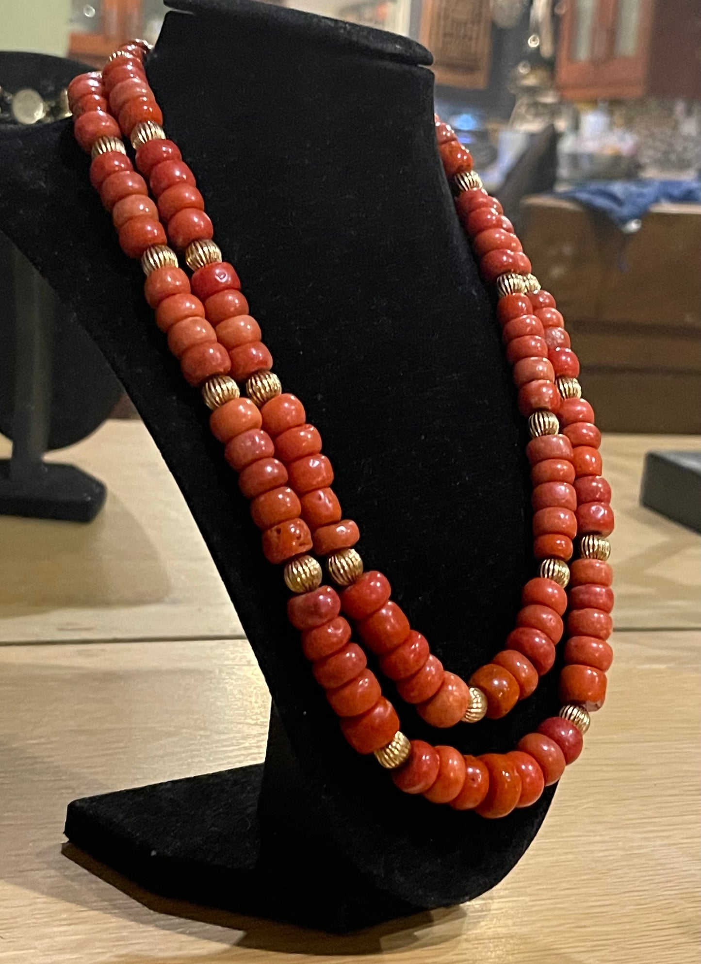 A coral and gold bead necklace