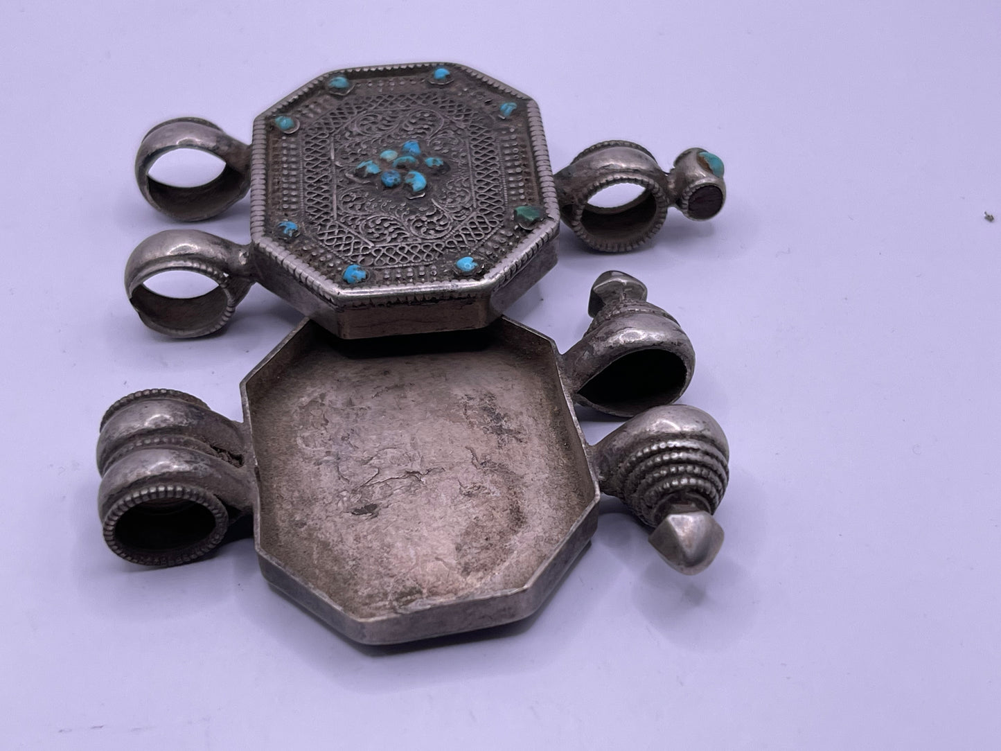 An antique 19th C., few Tibetan silver ghau with silver filigree and turquoise.