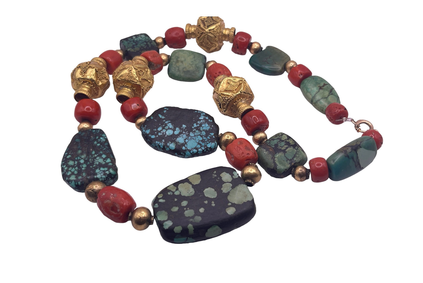 A necklace with antique Tibetan turquoise beads, coral beads and gold beads