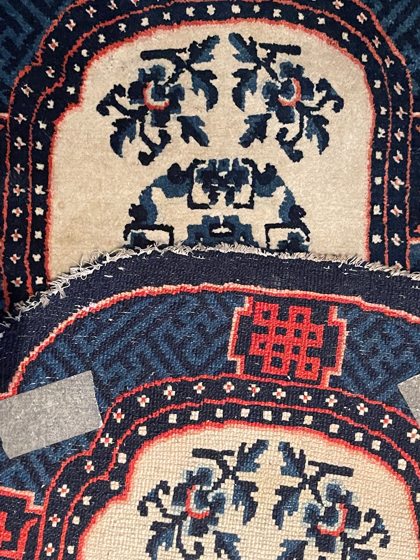 A vintage Tibetan indigo rounded woolen saddle rug