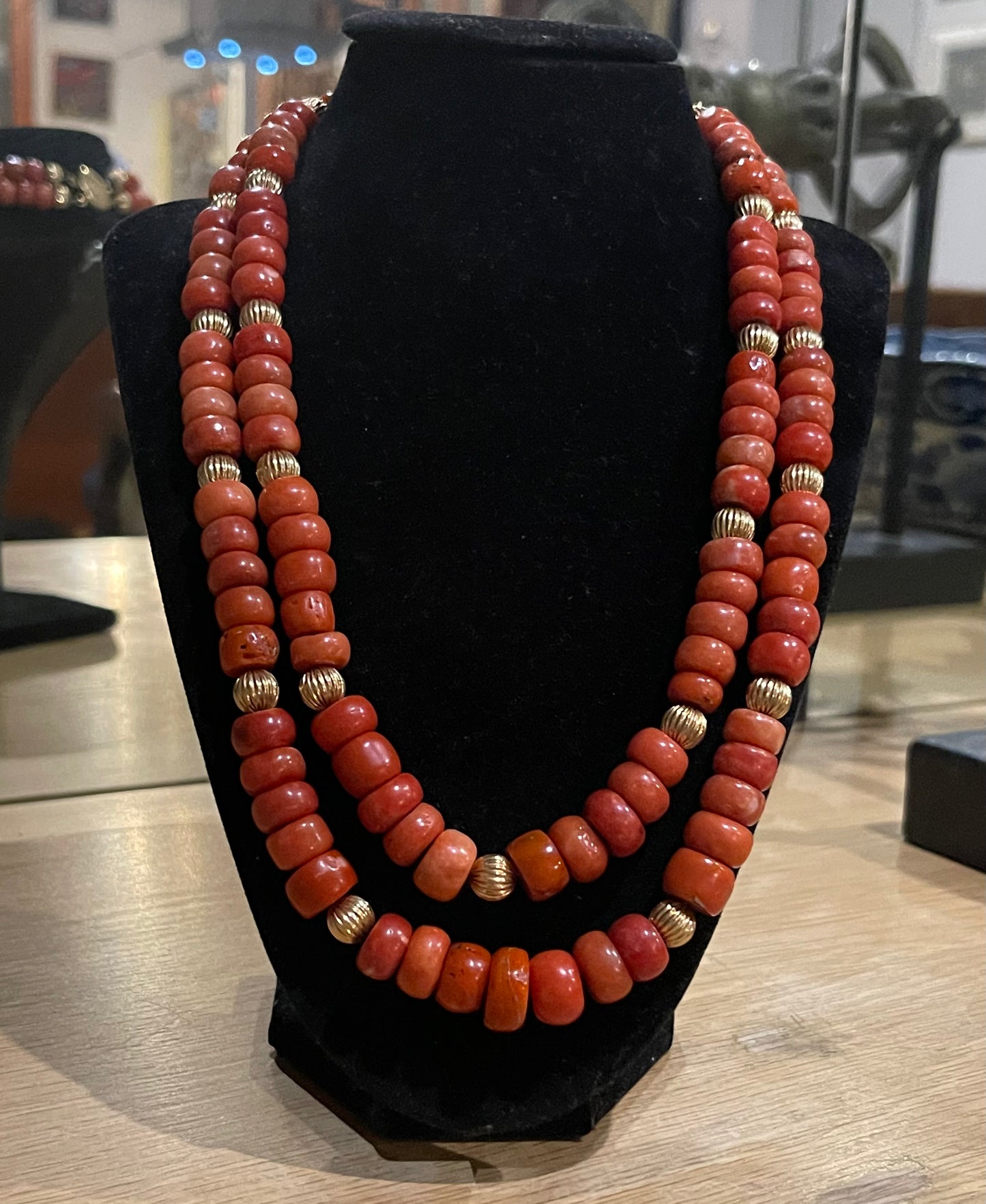 A coral and gold bead necklace
