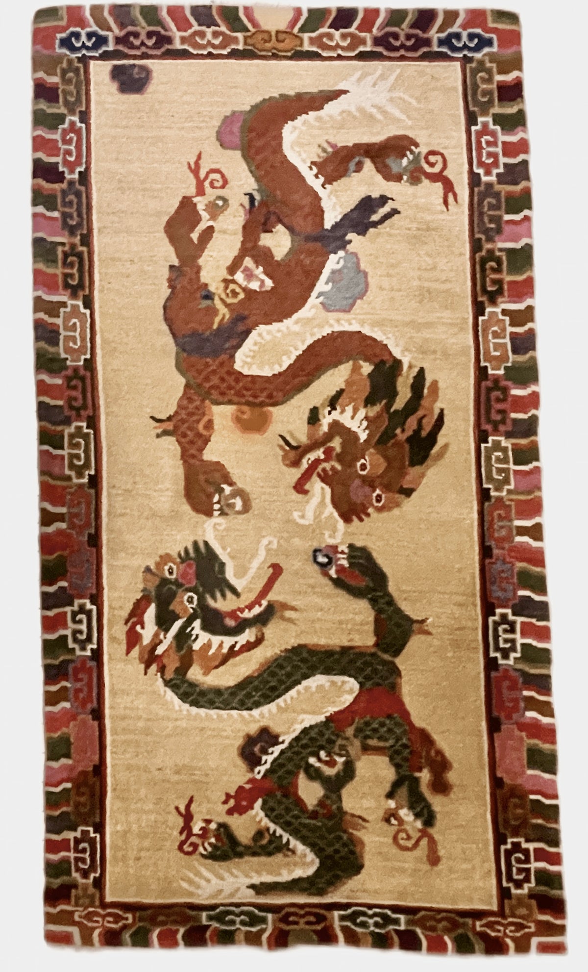 A vintage mid 20th c. Tibetan rug with dragons