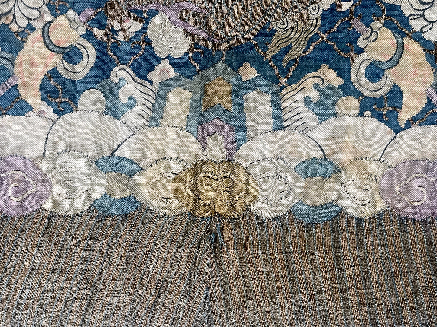 An antique framed Chinese silk kesi of a pair of dragons